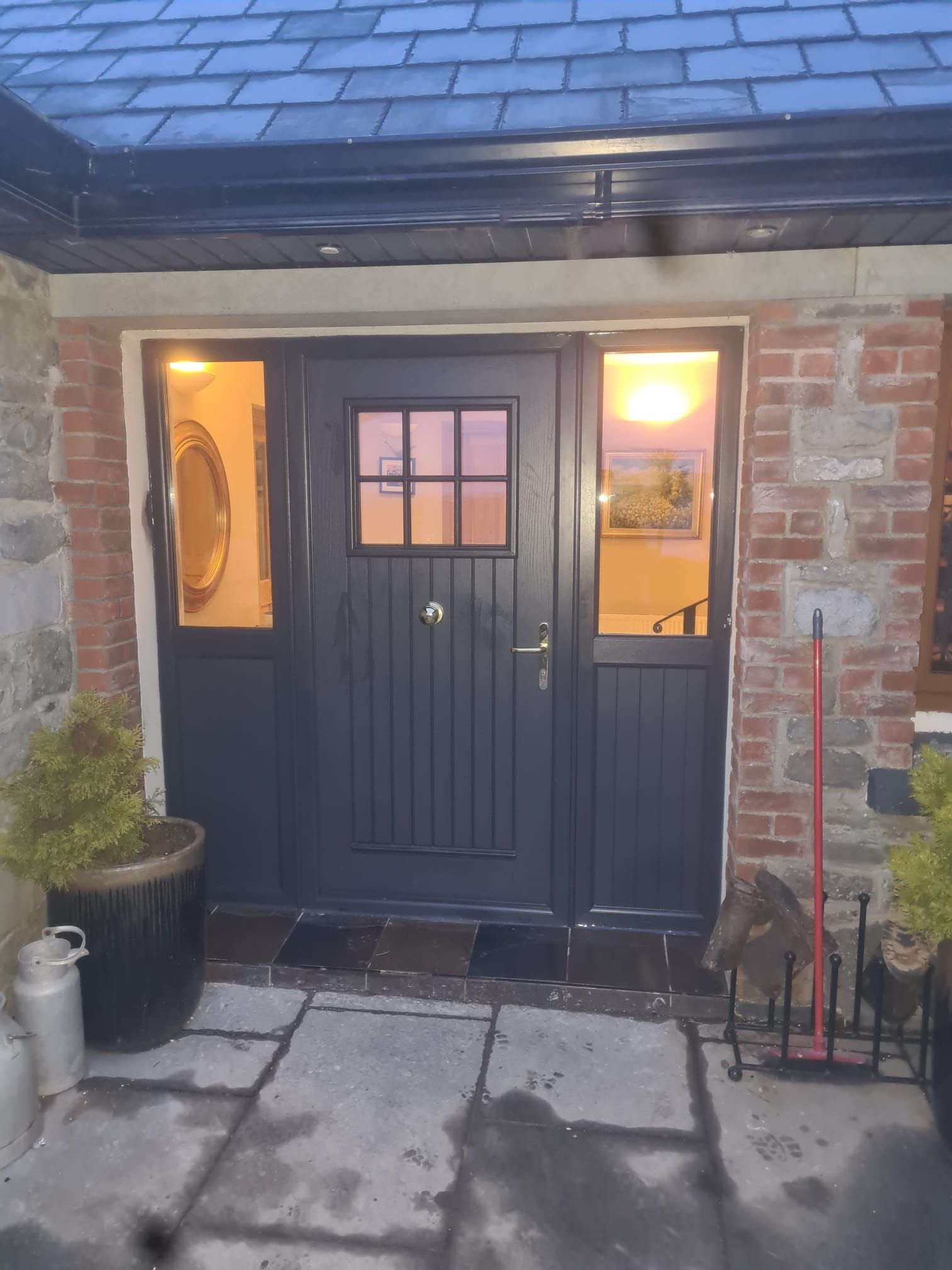 The front door of a brick house with a black door
