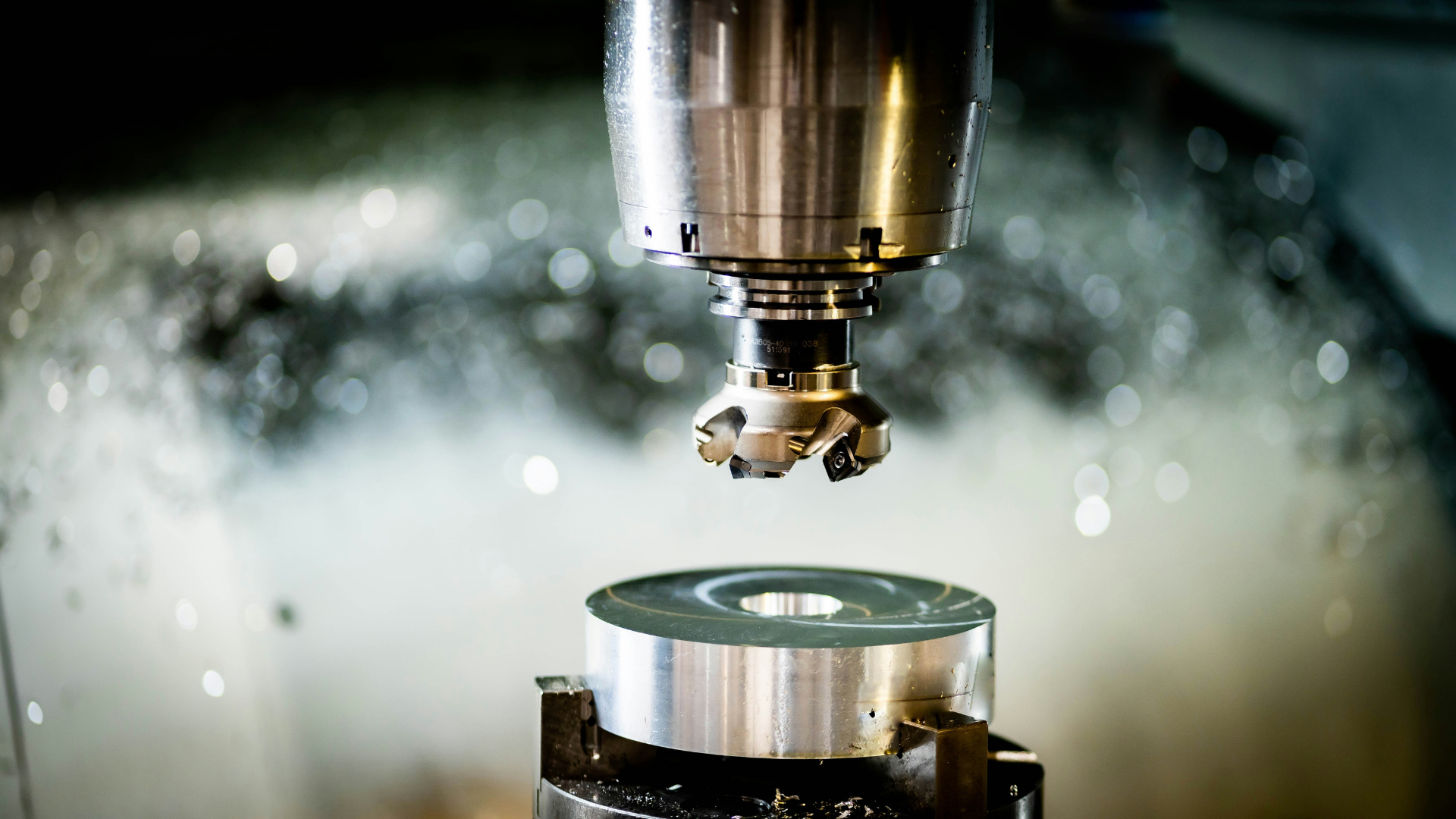 CNC machine milling a metal cylinder.