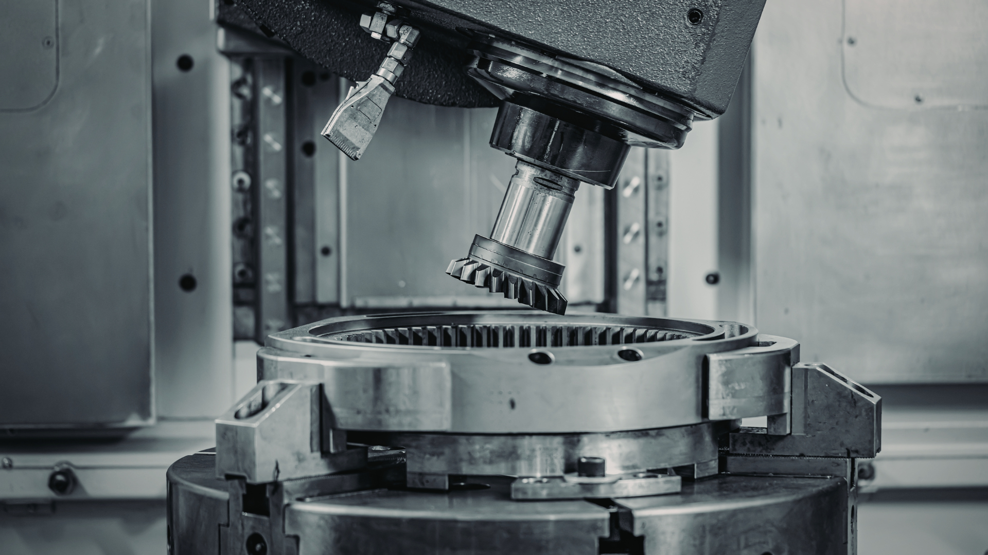 CNC machine cutting a gear, industrial setting.