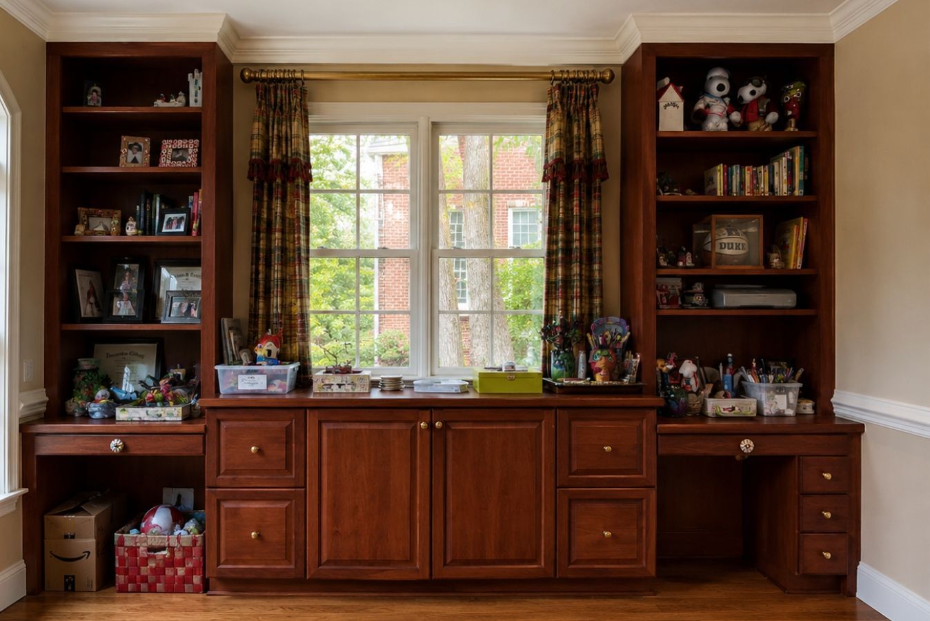Built-in wooden cabinets and shelves framing a window in a cozy living room.