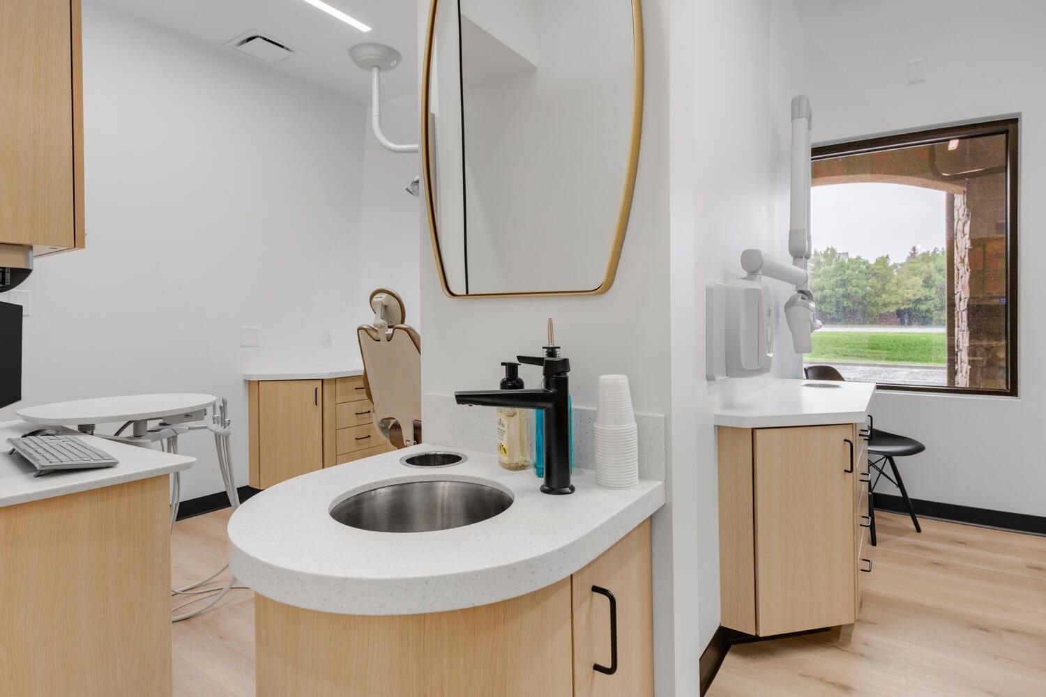 a dental office with a sink and a mirror .