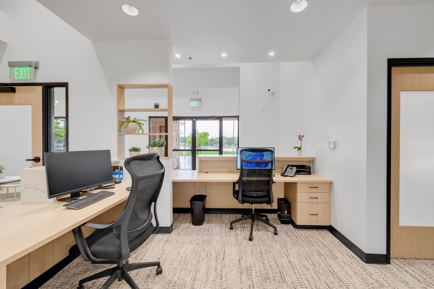 a room with two desks and two chairs in it .