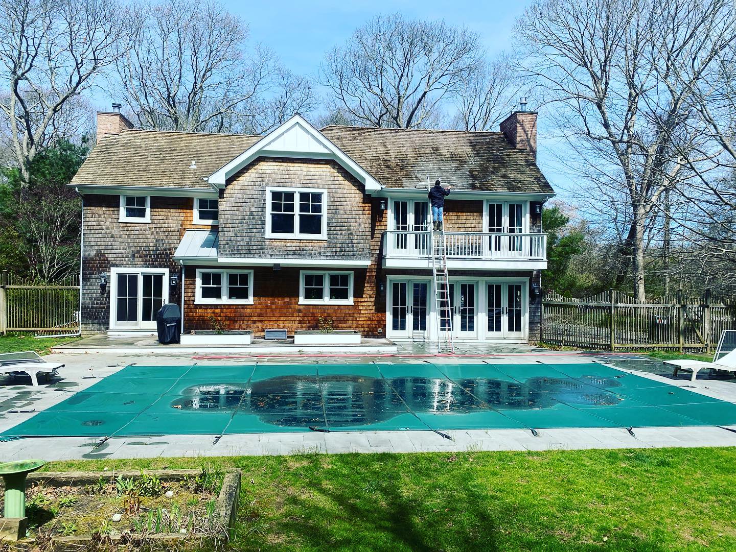 a large house with a large swimming pool in front of it .