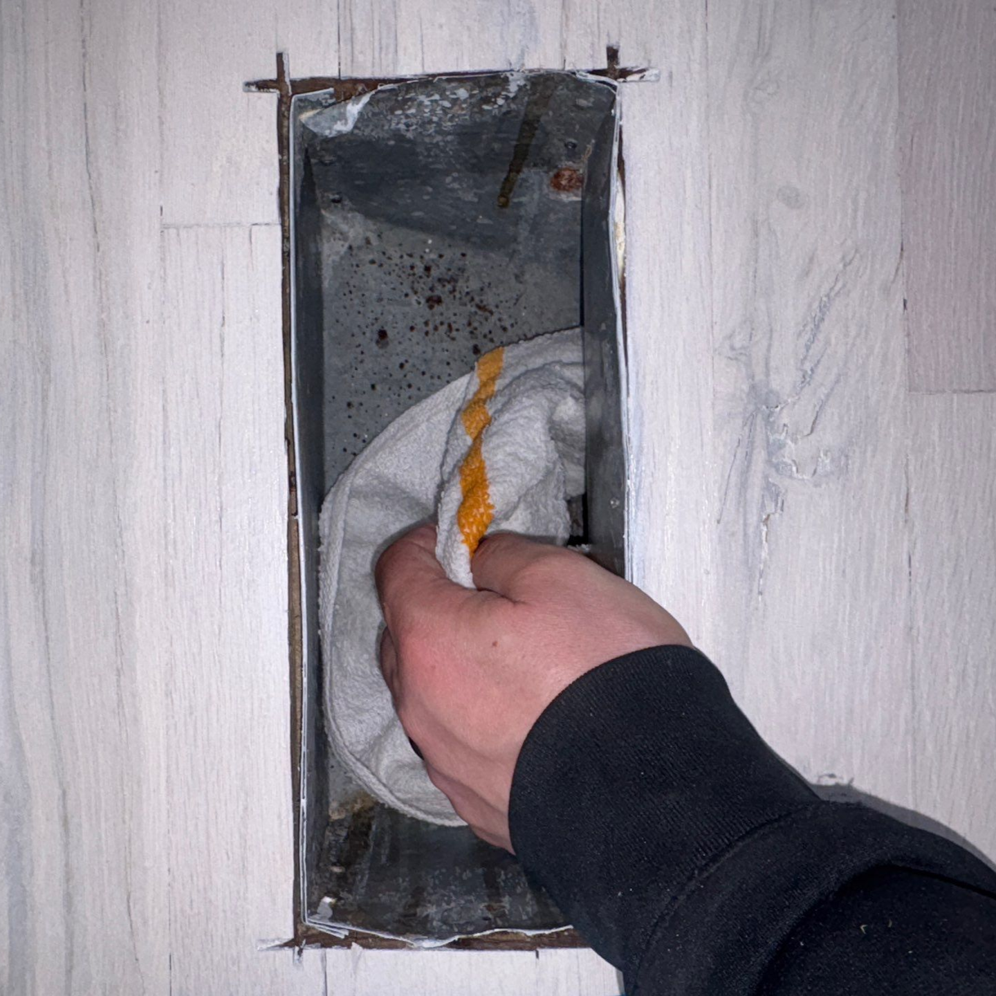 hand cleaning the HVAC registers at a Westhampton Beach home.