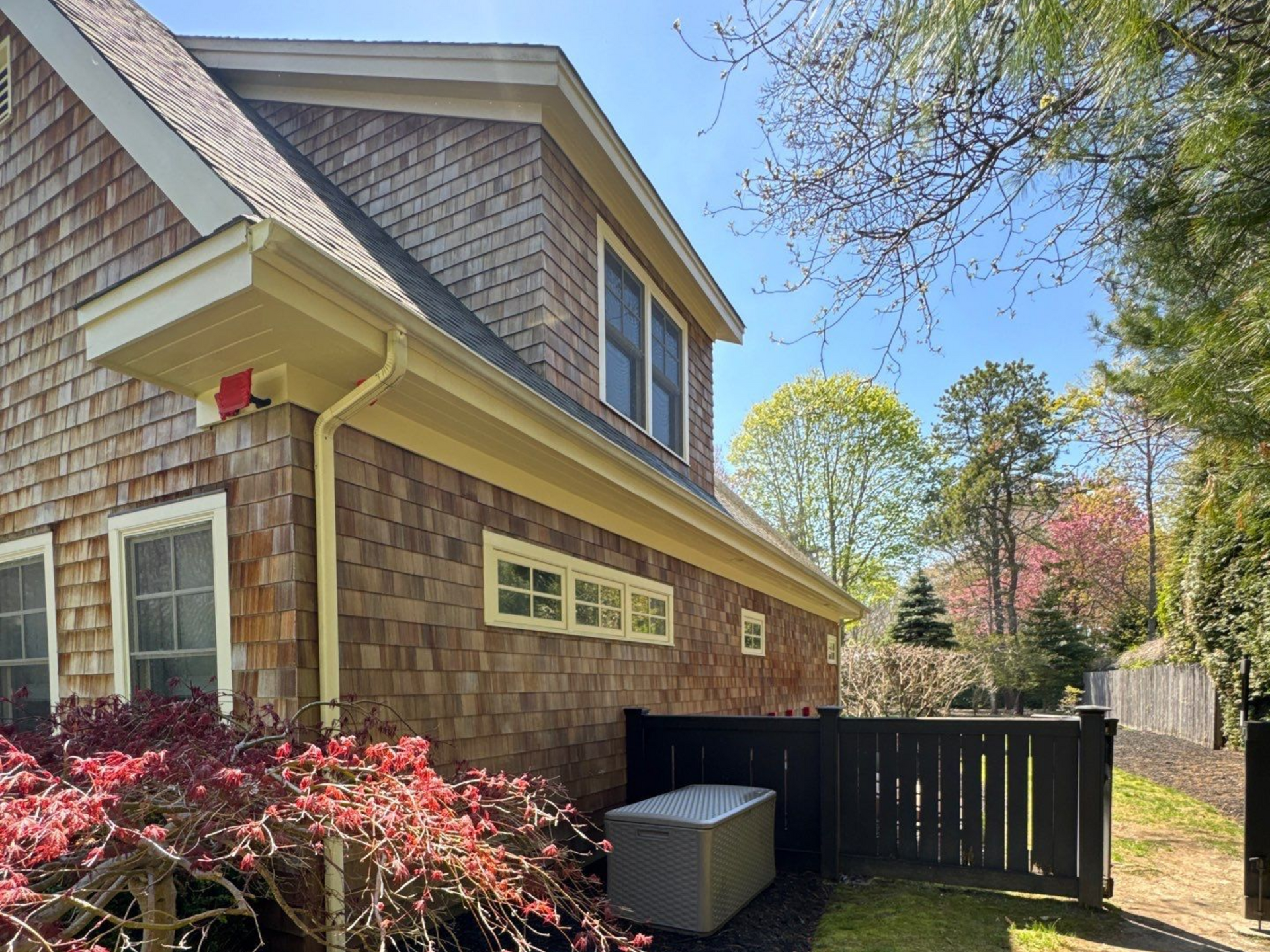 Back of home in Westhamton after soft washing of cedar shake siding.