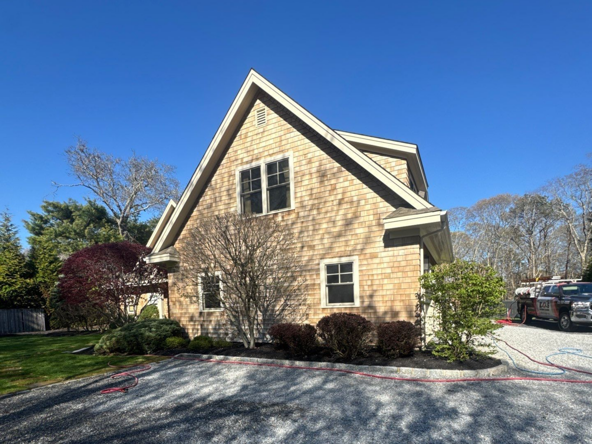 Cleaned cedar shake siding after soft washing at home in Westhampton NY