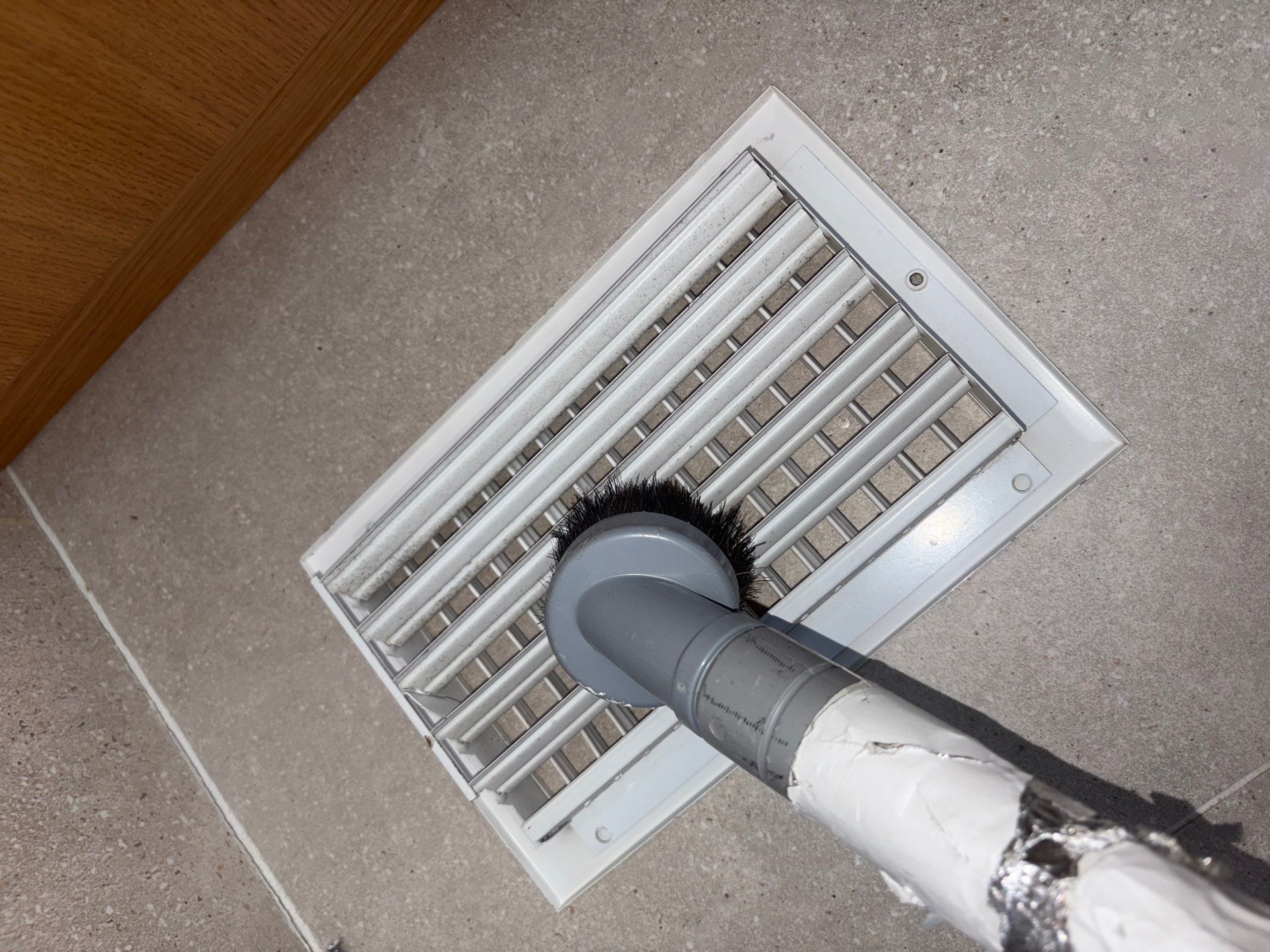 Vacuuming the HVAC vent registers at a Westhampton Beach home.