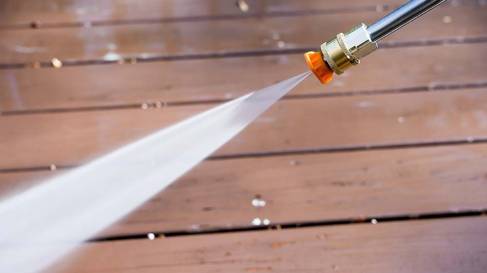 Pressure washing services on a deck at a home on Long Island.