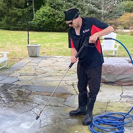 pressure washing a patio at a home in Suffolk County NY