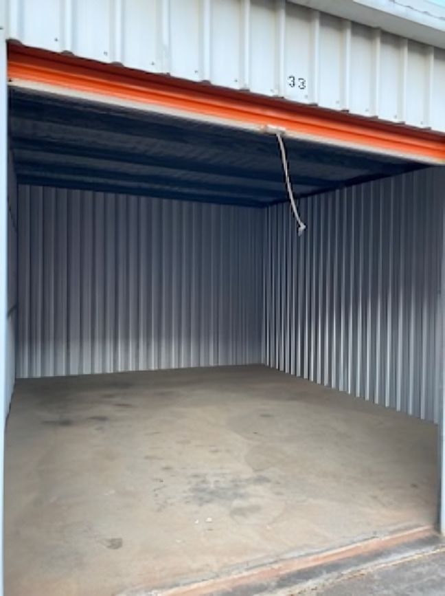 An empty garage with the door open and the number 33 on the side. — Acacia Mini Storage in Port Macquarie, NSW
