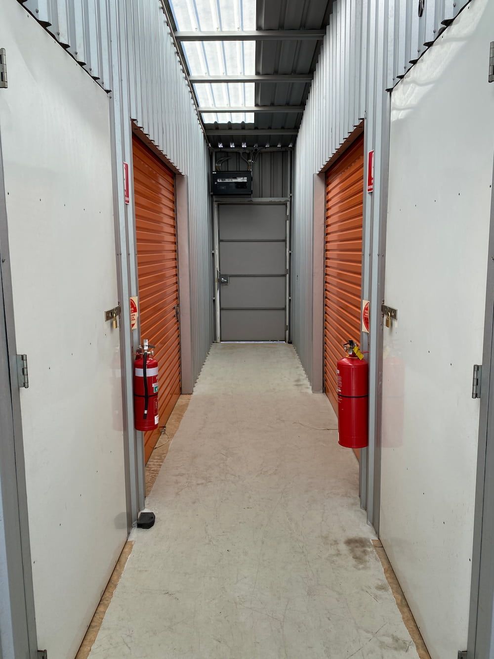 A Long Hallway With A Fire Extinguisher On The Side Of It — Acacia Mini Storage in Port Macquarie, NSW