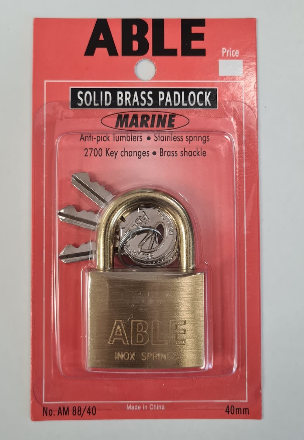 A solid brass padlock is in a red package — Acacia Mini Storage in Port Macquarie, NSW
