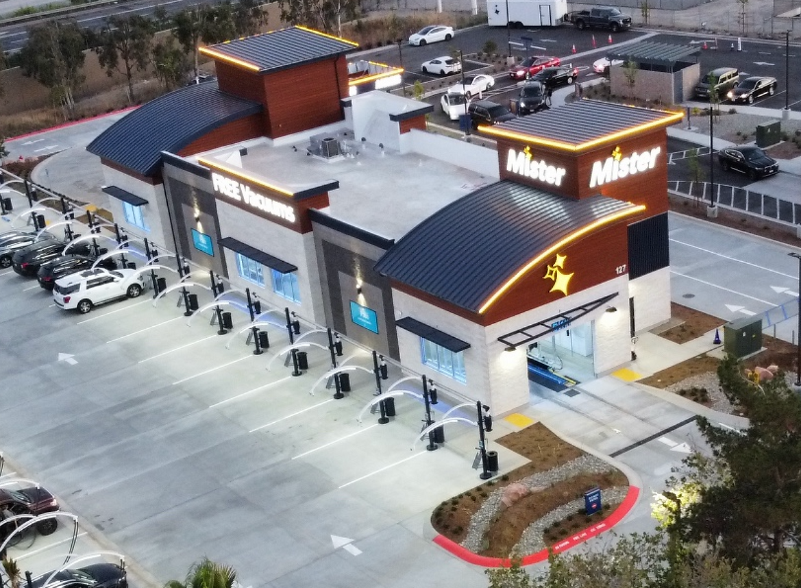 Aerial view of a modern McDonald's with a parking lot and drive-through area at dusk
