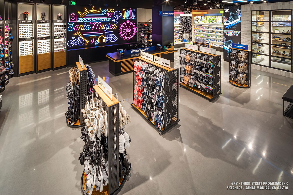 Bright electronics store interior with aisles of phone accessories and colorful illuminated displays