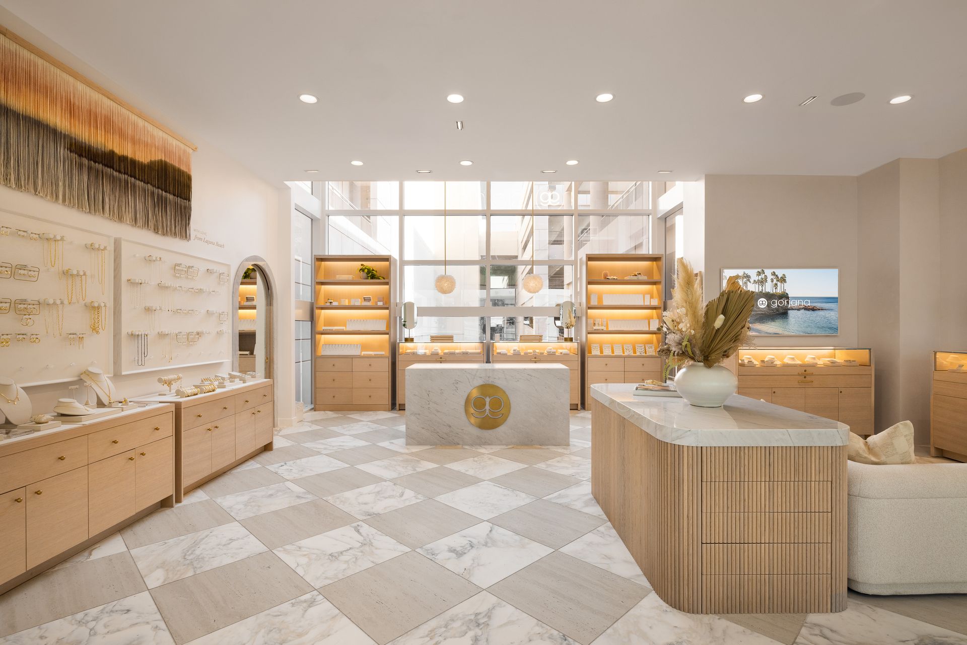 Bright minimalist boutique interior with wood displays, shelves, neutral decor, and soft beige tones