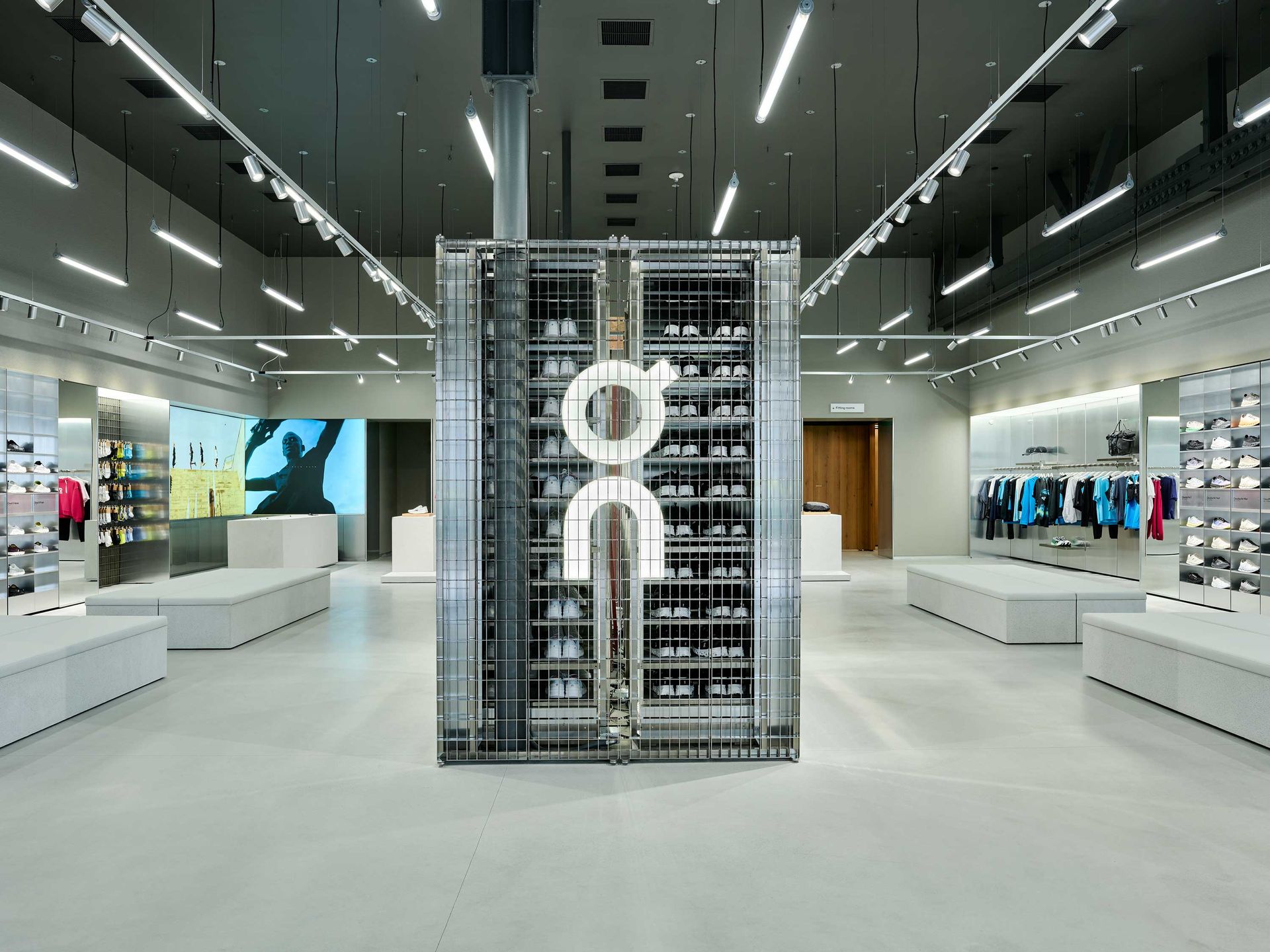 Modern retail store interior with a central display tower and bright overhead lighting