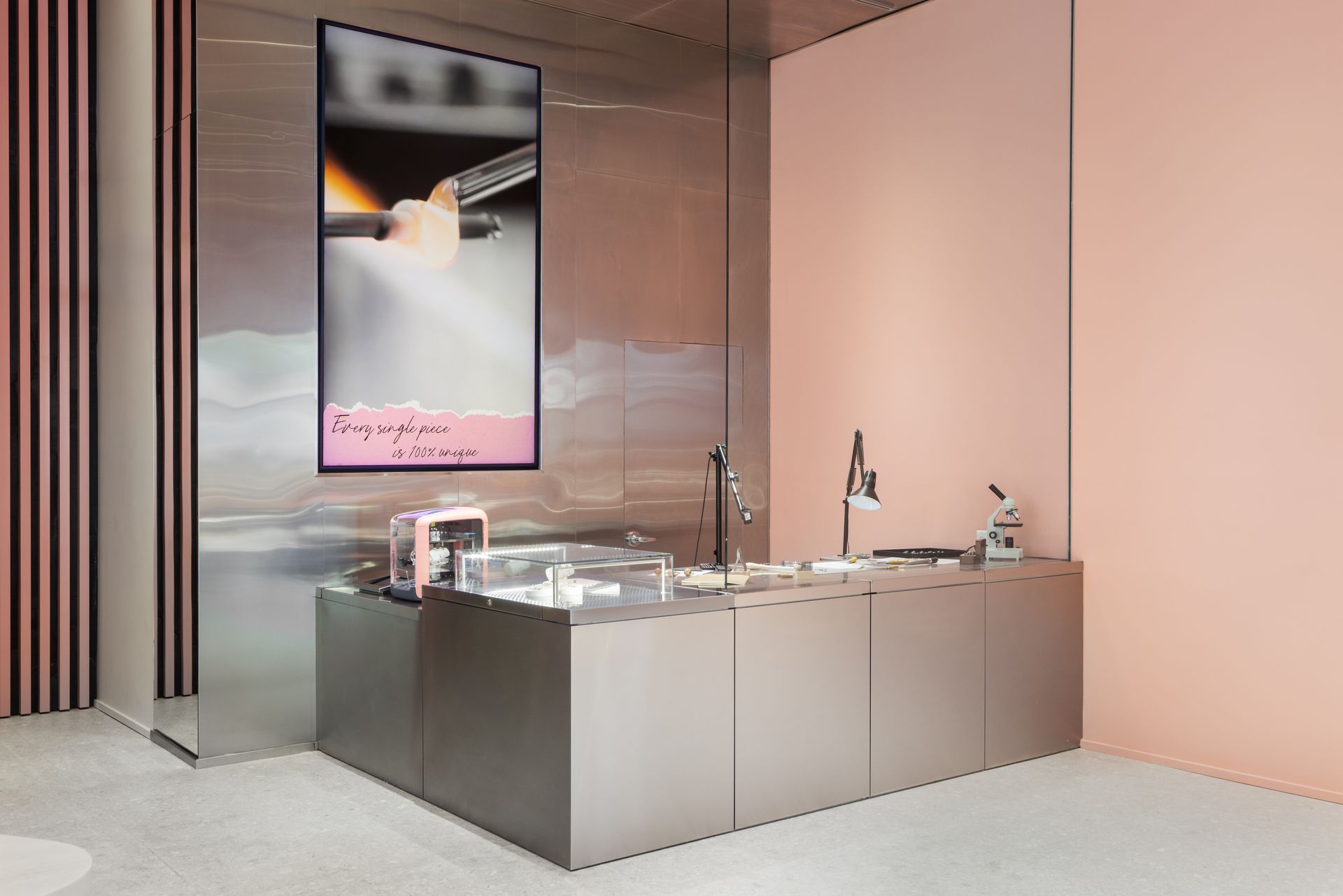 Modern bathroom with a glass-enclosed tub, sink, and wall mirror in a minimalist pink-toned room
