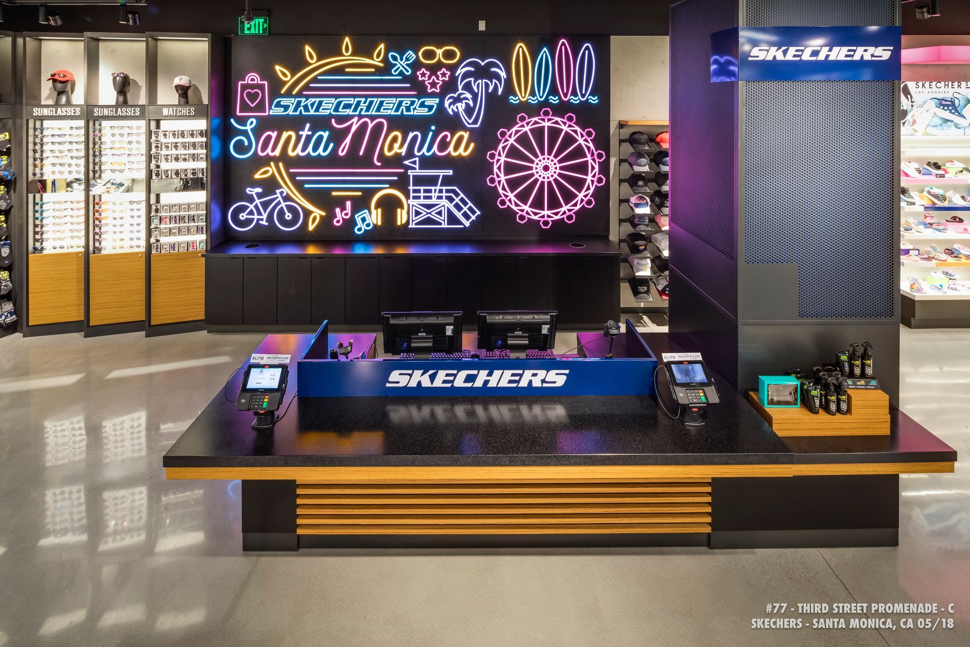 Skechers store display with neon Santa Monica sign, shoes, and illuminated holiday-themed decor