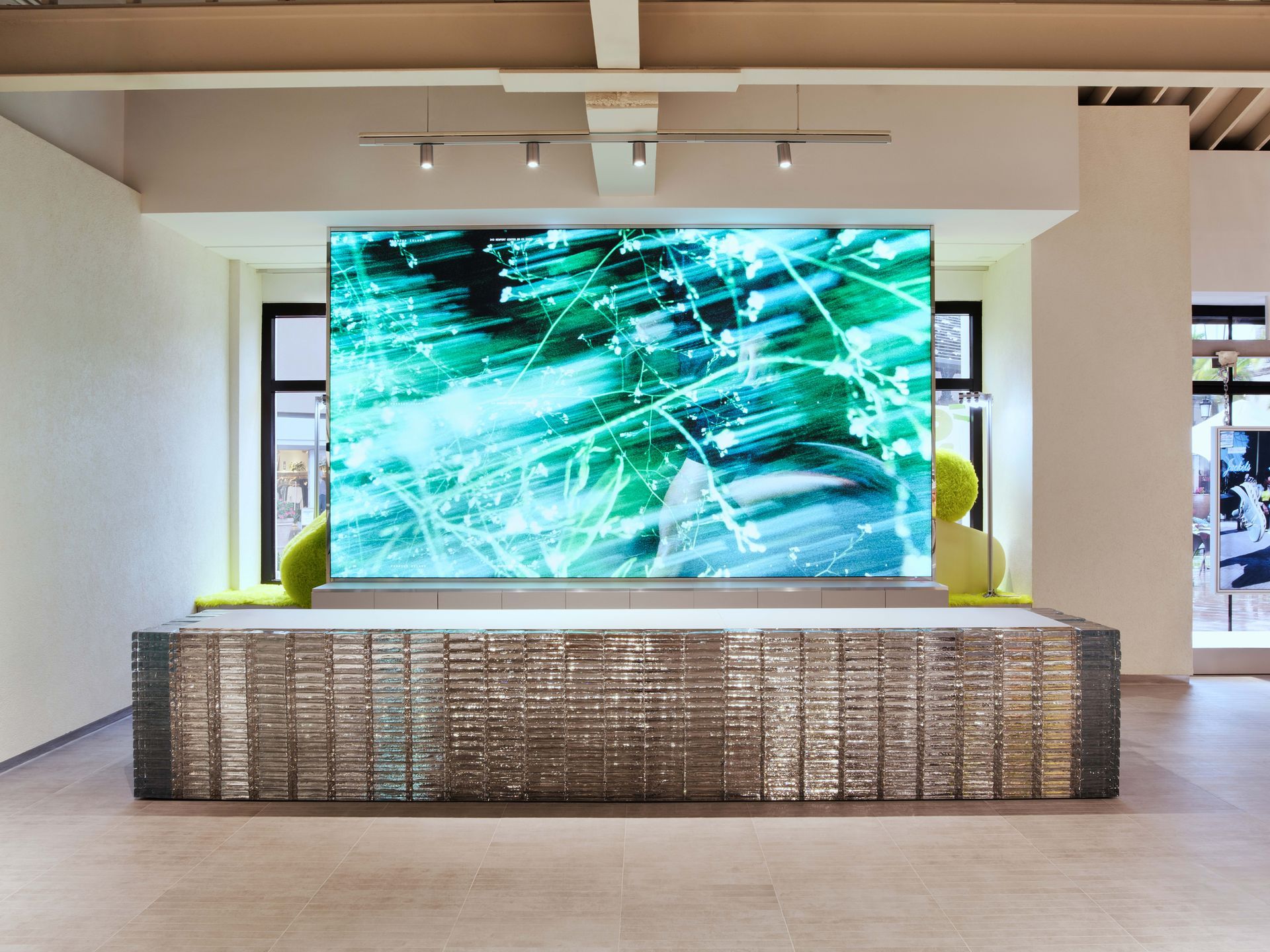 Large digital art display with abstract teal streaks in a modern gallery or lobby setting