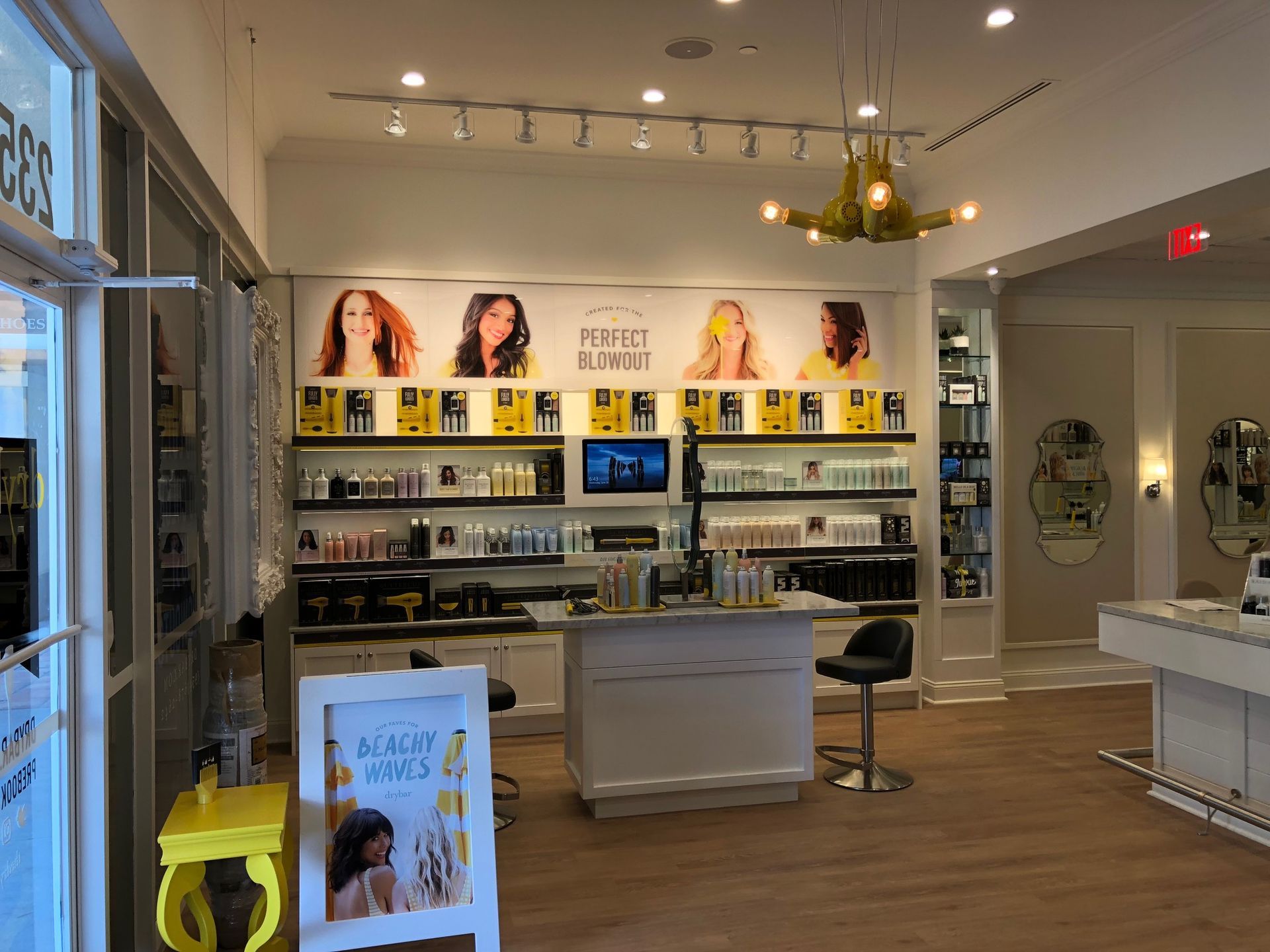 Bright beauty store interior with product shelves, display tables, and posters under warm ceiling lights