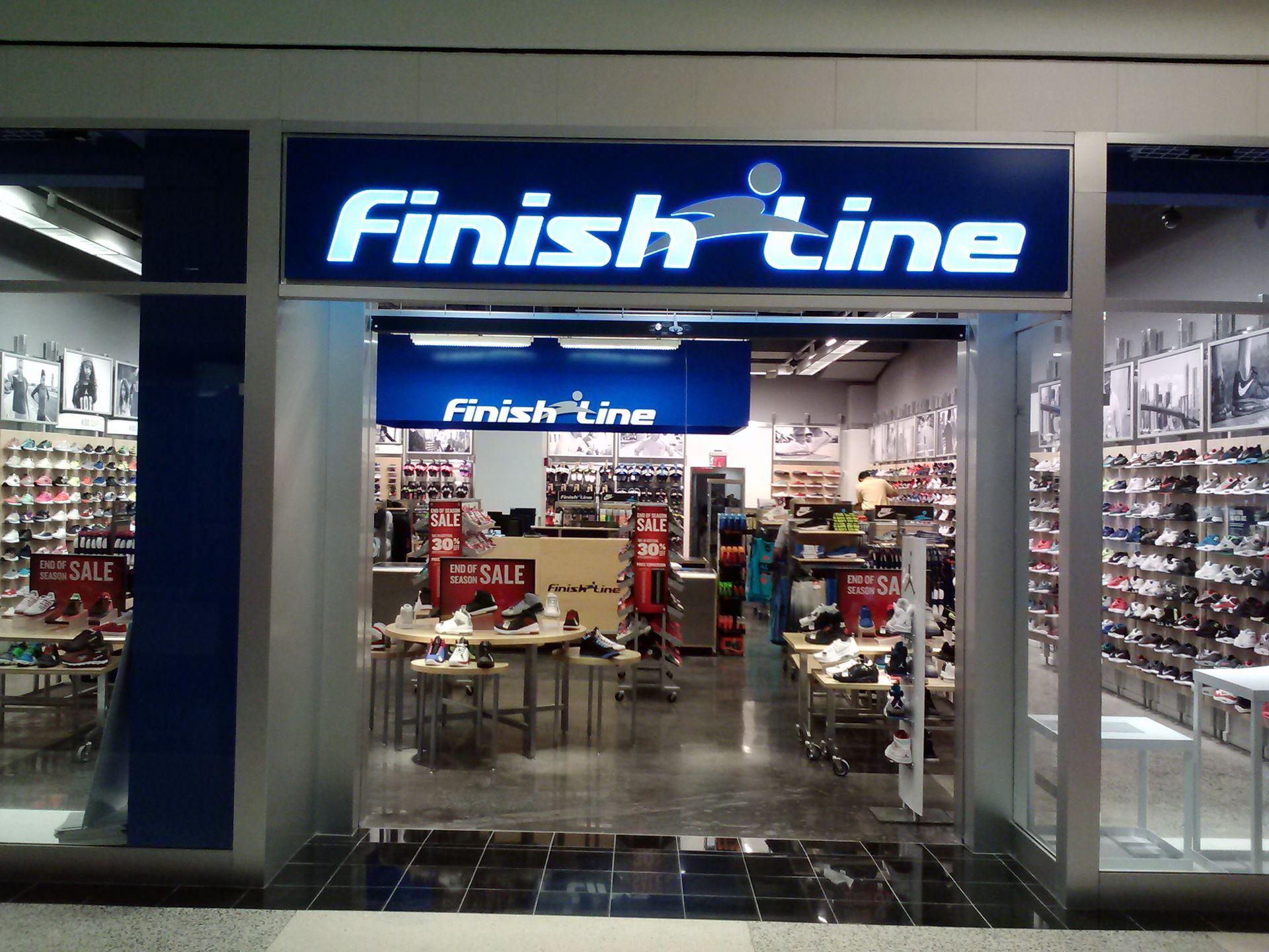 Finish Line shoe store entrance with blue sign and sneaker displays inside