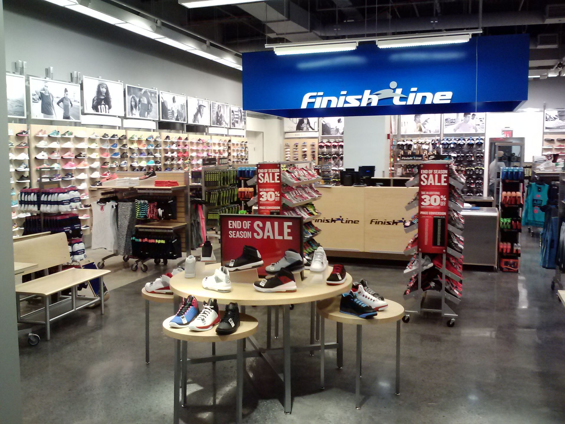 Finish Line shoe store interior with sneakers, sale displays, and blue sign above the counter