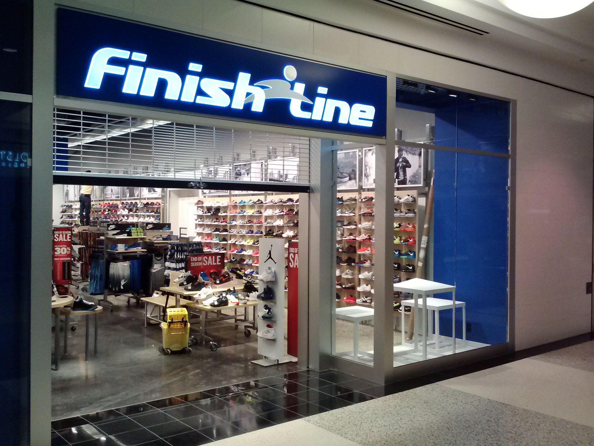 Finish Line store storefront in a shopping mall, with blue signage and glass entrance.