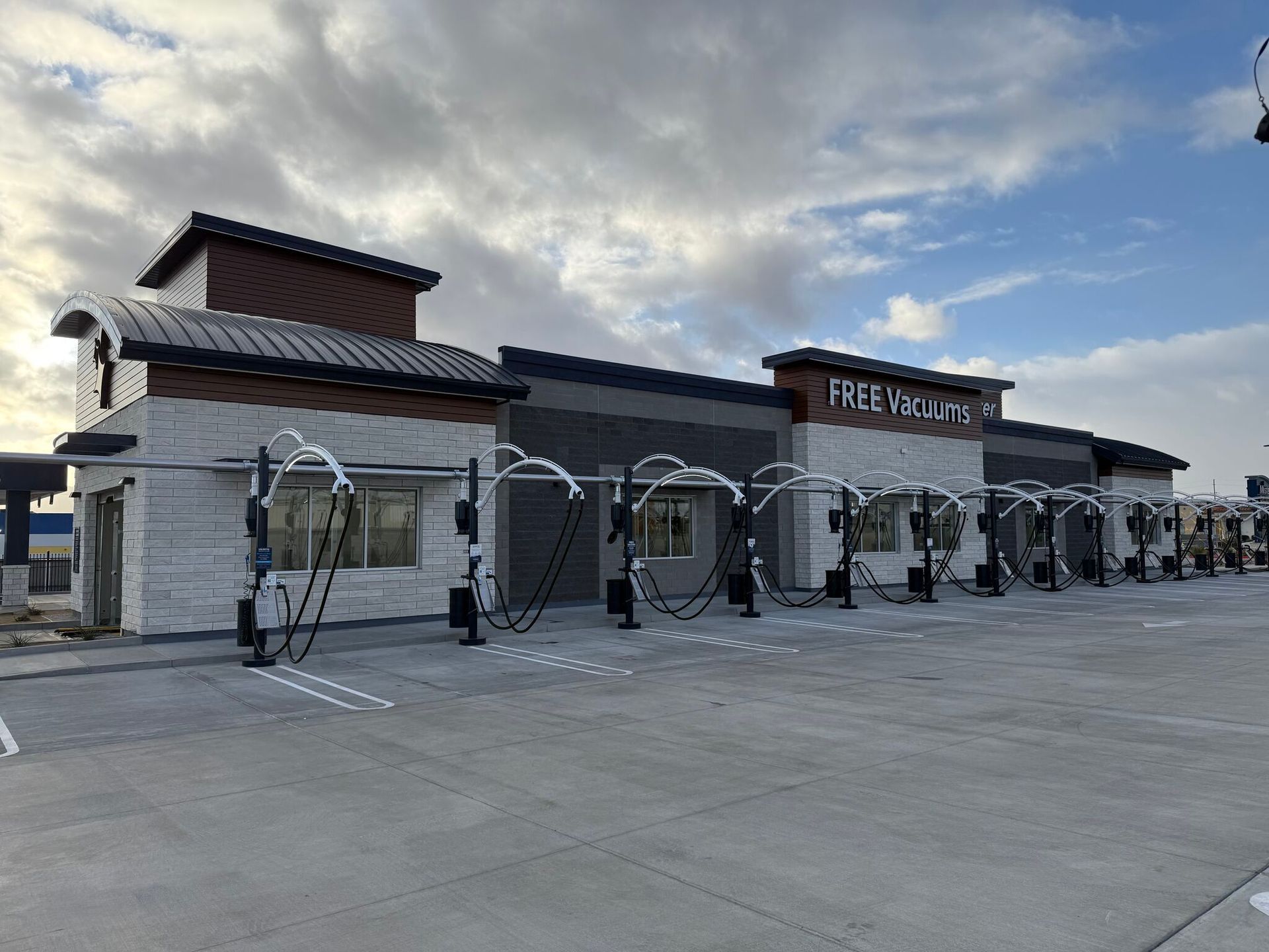FEEV warehouse storefront with metal cargo containers displayed in front under a cloudy sky
