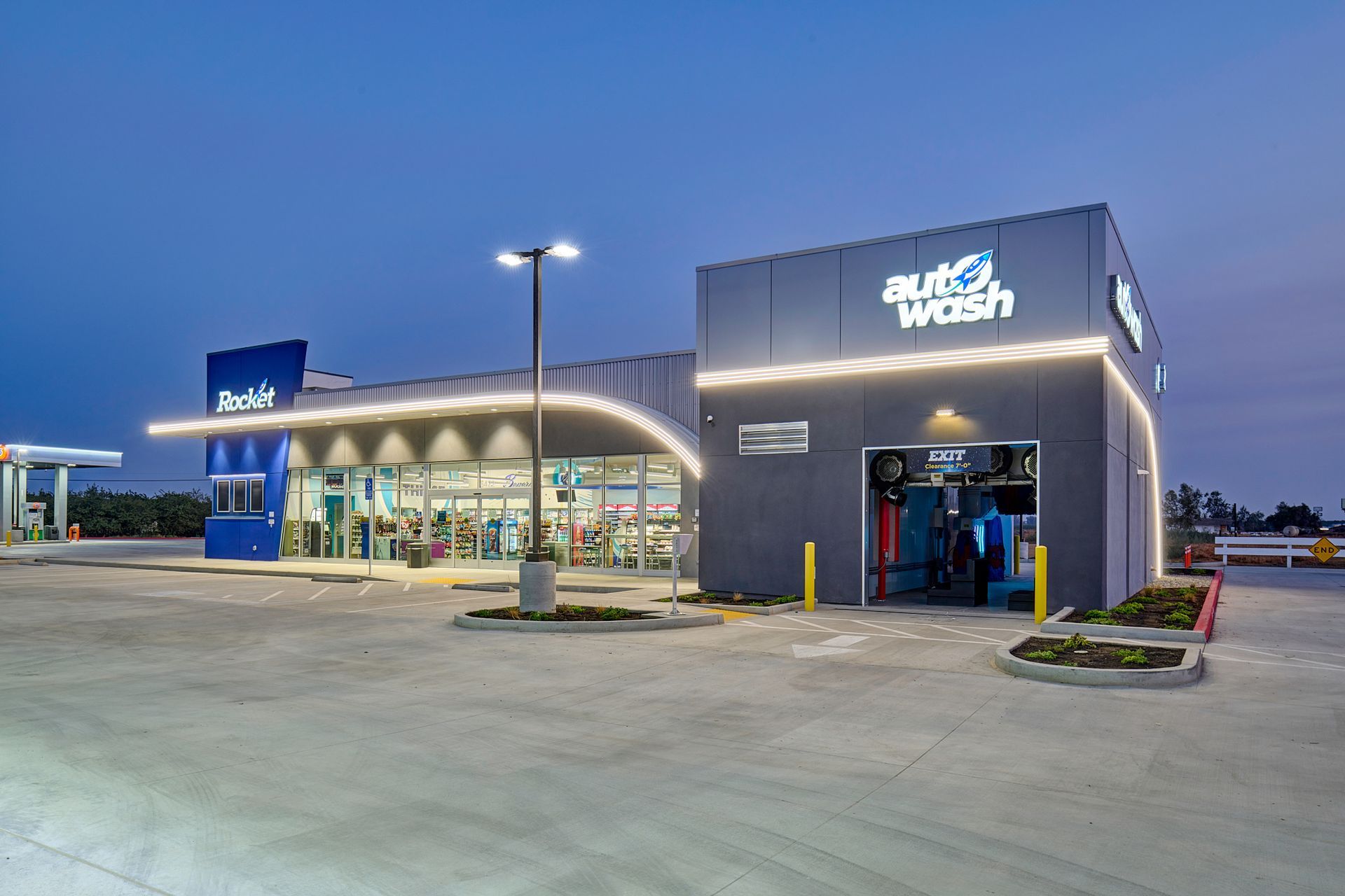 Blue Witch store exterior at dusk, with illuminated signage and a modern glass storefront.