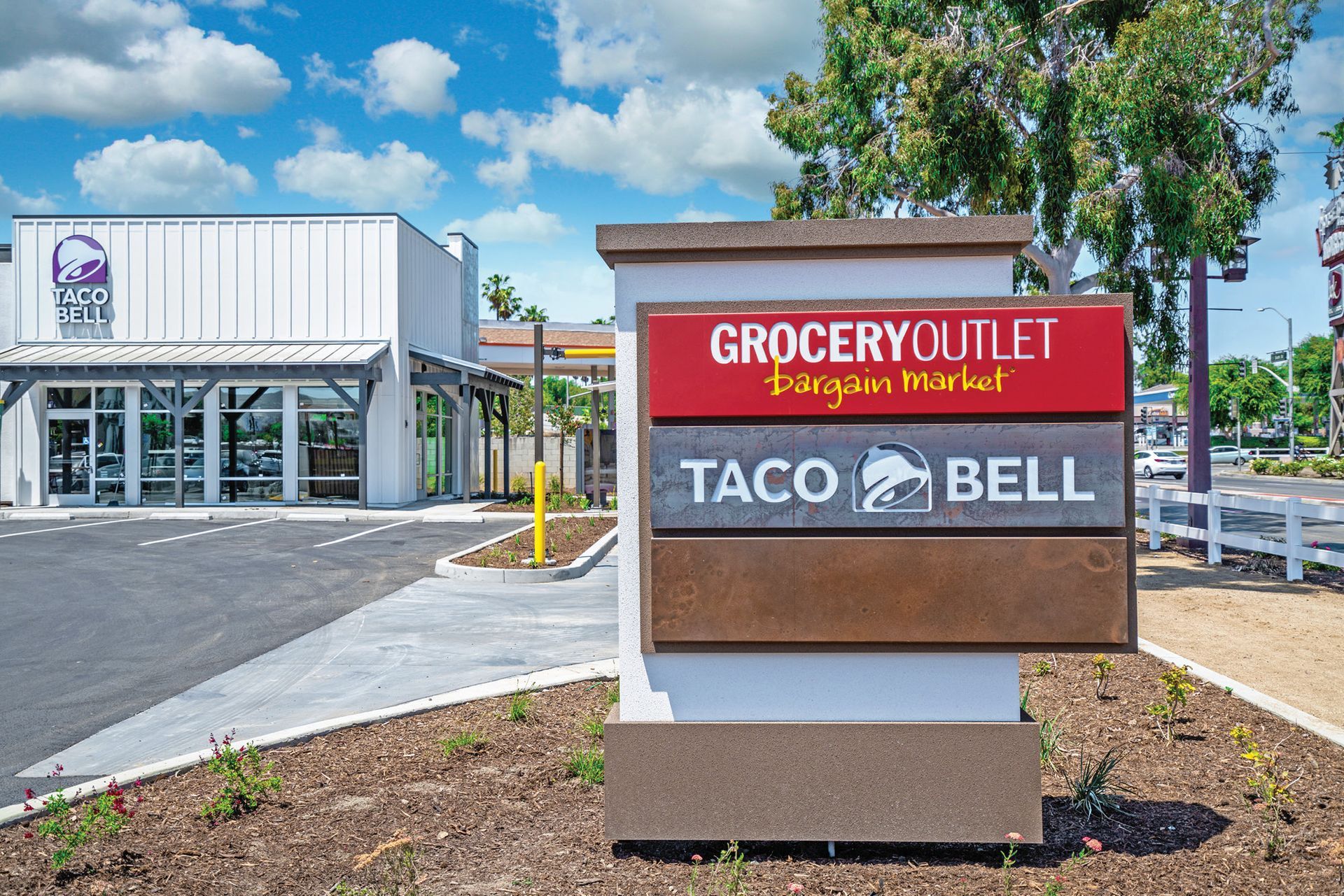 Grocery Outlet and Taco Bell storefronts with a roadside sign in front