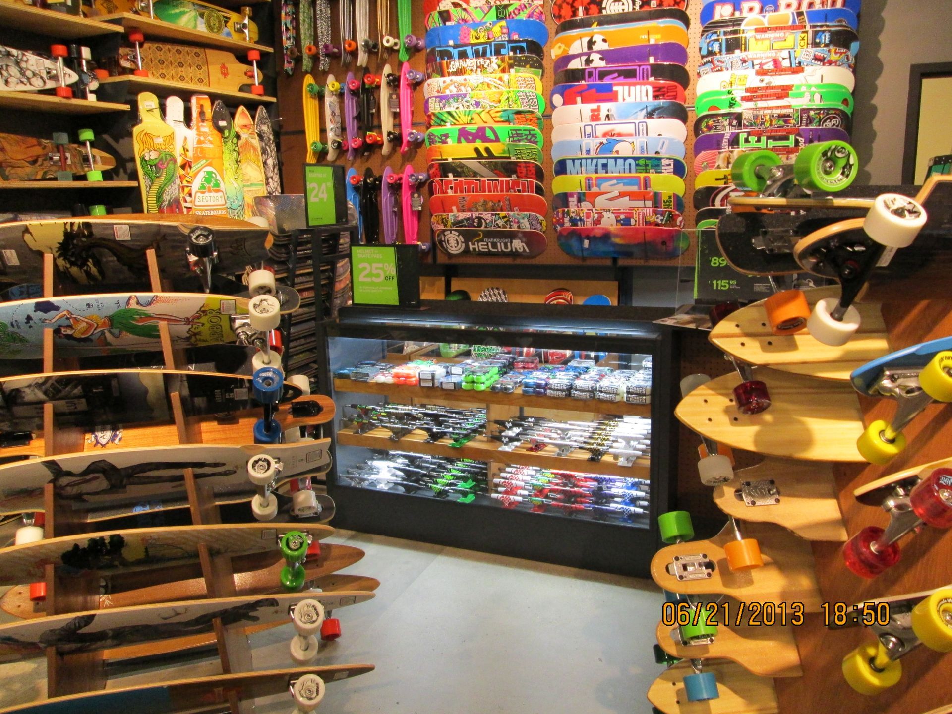 Colorful skateboard shop interior with rows of boards, shelves of gear, and a display counter.