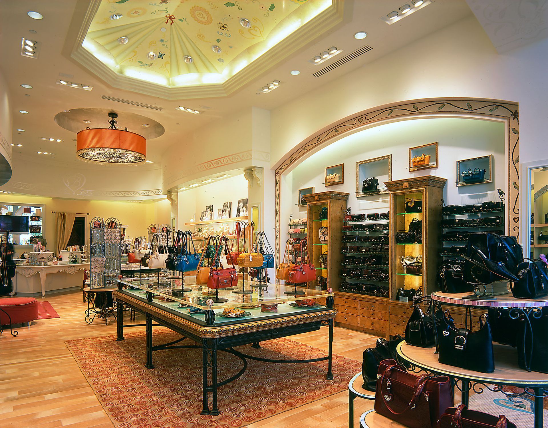 Upscale boutique interior with jewelry displays, chandeliers, and ornate decor