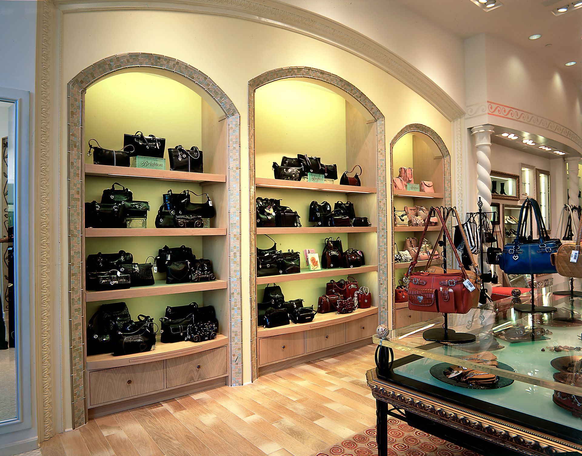 Elegant boutique shelves displaying handbags and accessories in a softly lit store interior.