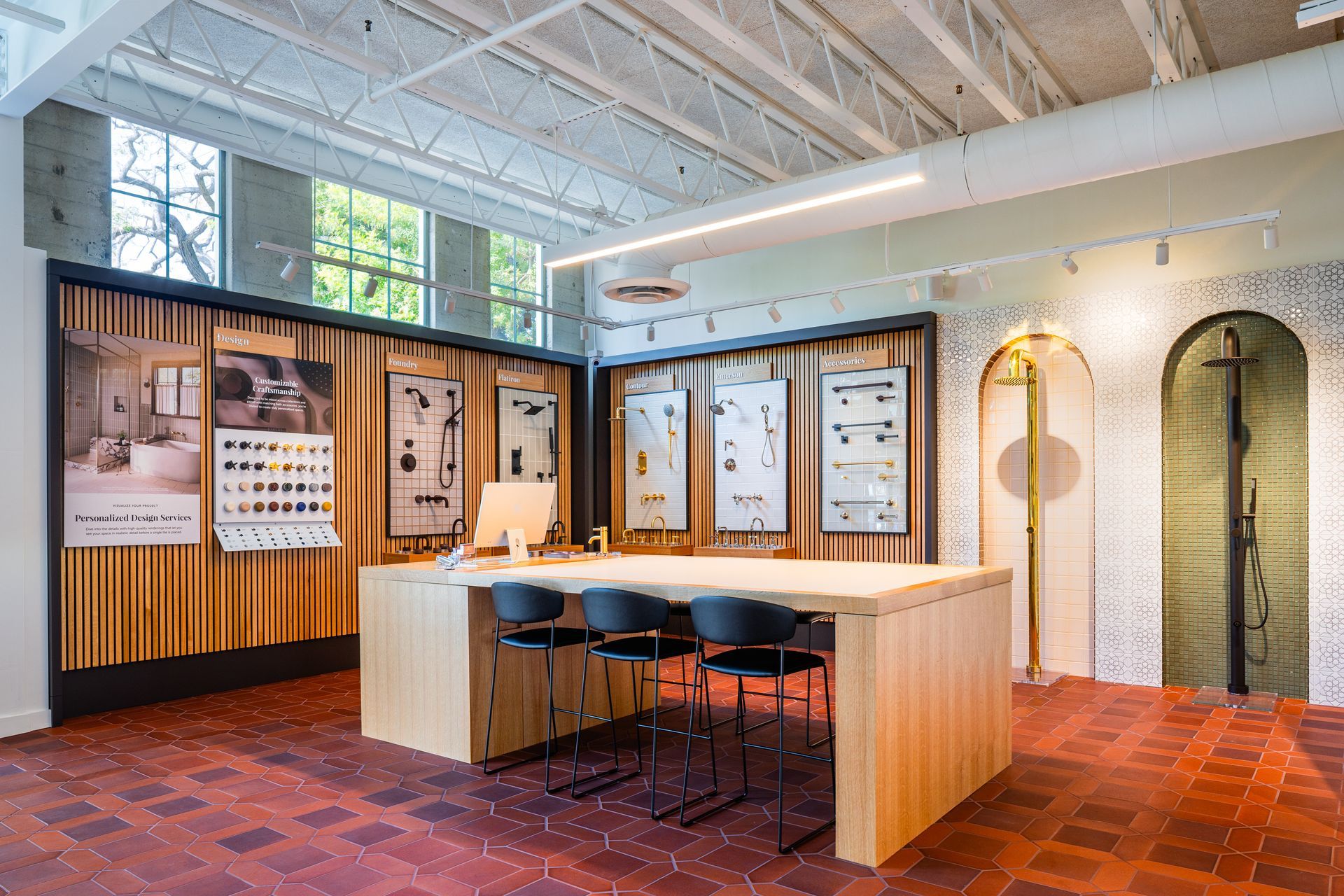 Modern office lounge with wood-paneled counter, bar stools, arched doorways, and exposed white ceiling beams.
