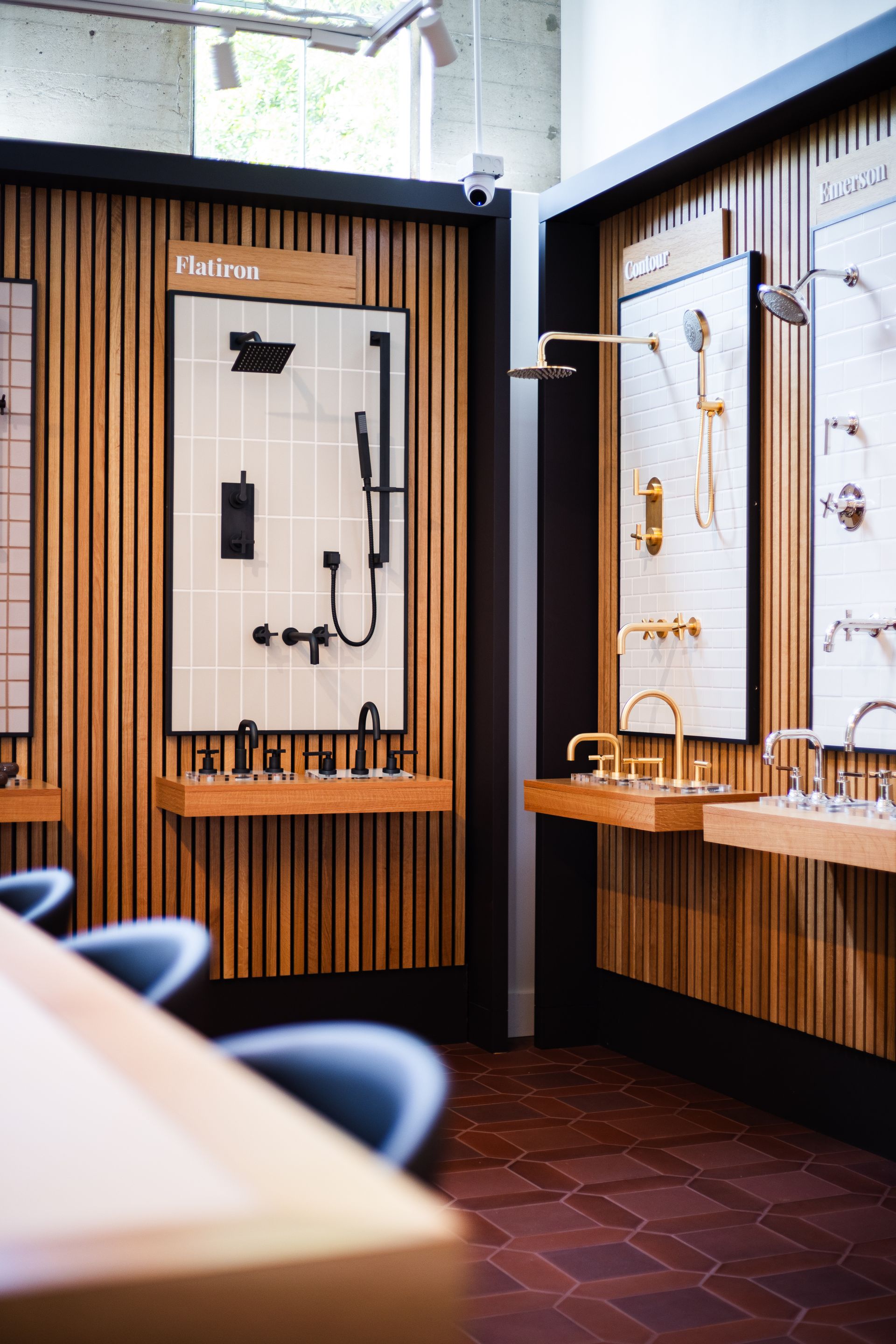 Modern showroom with wall-mounted faucets and sinks in a wood-paneled bathroom display