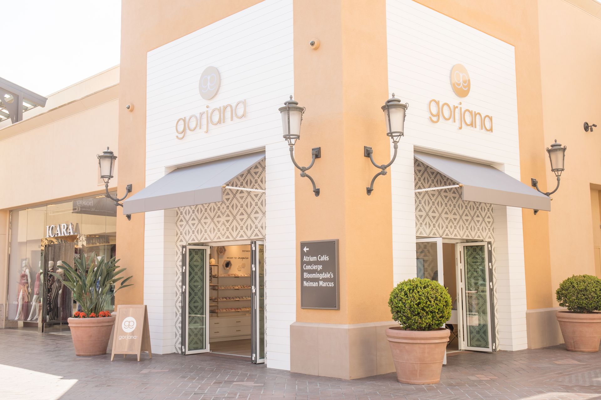 Corner storefront of Gorgana bakery with orange-white exterior and potted plants outdoors