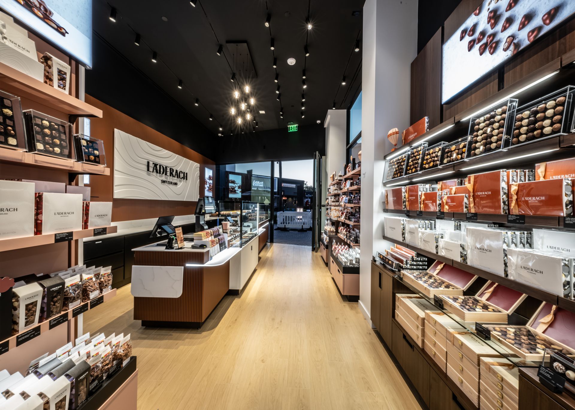Modern retail store interior with wooden shelves, display tables, and warm lighting