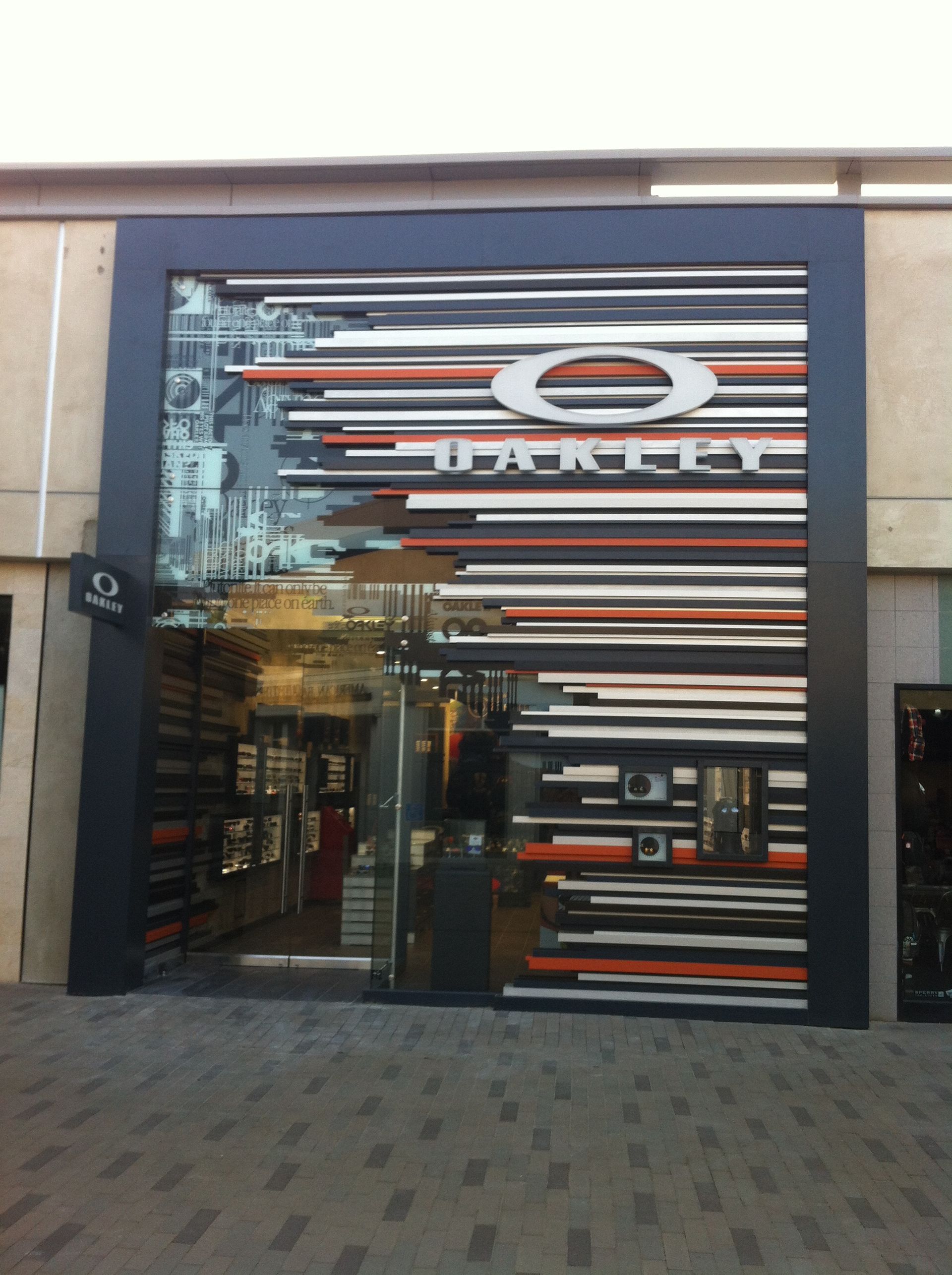 Storefront with a striped facade and glass entrance, likely a retail shop in a mall.