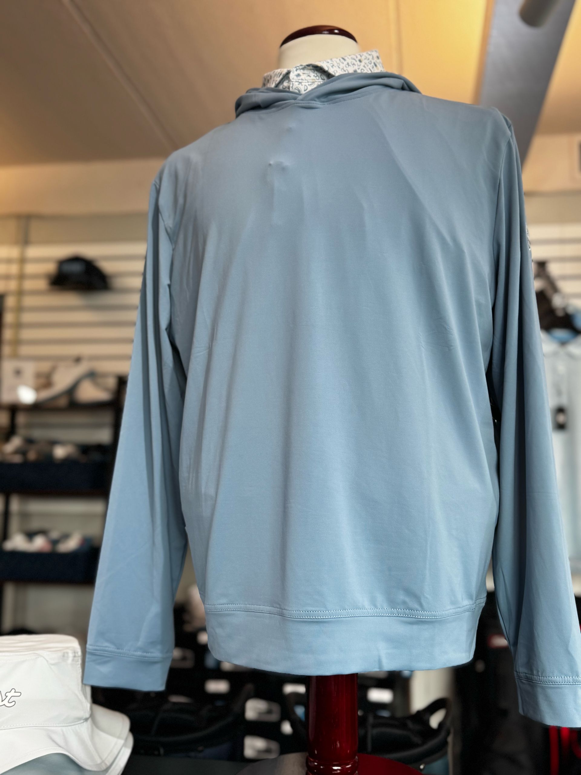 Light blue long-sleeve sweater on a mannequin in a clothing shop