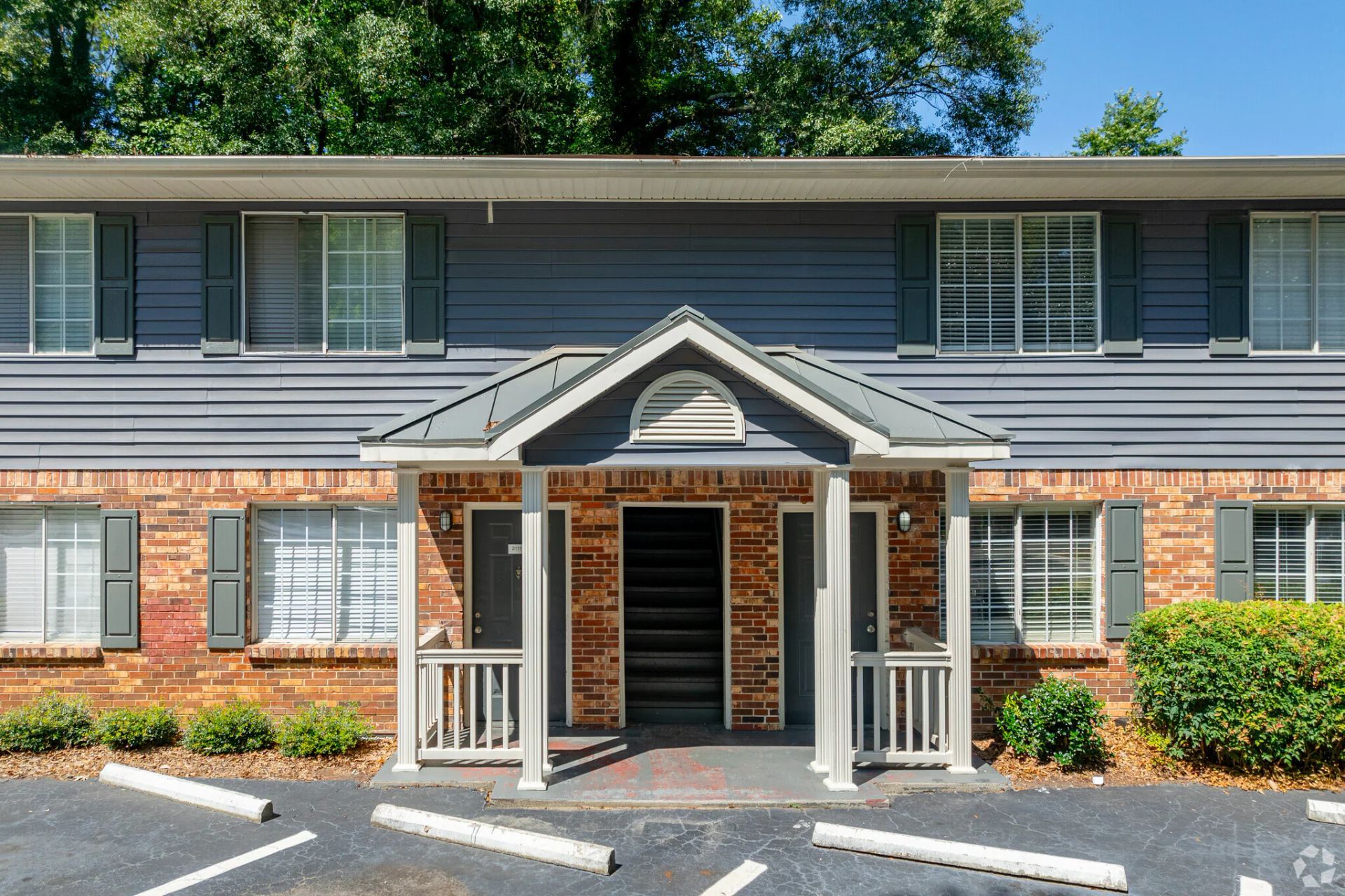 Photo of the entrance to a two-story apartment building