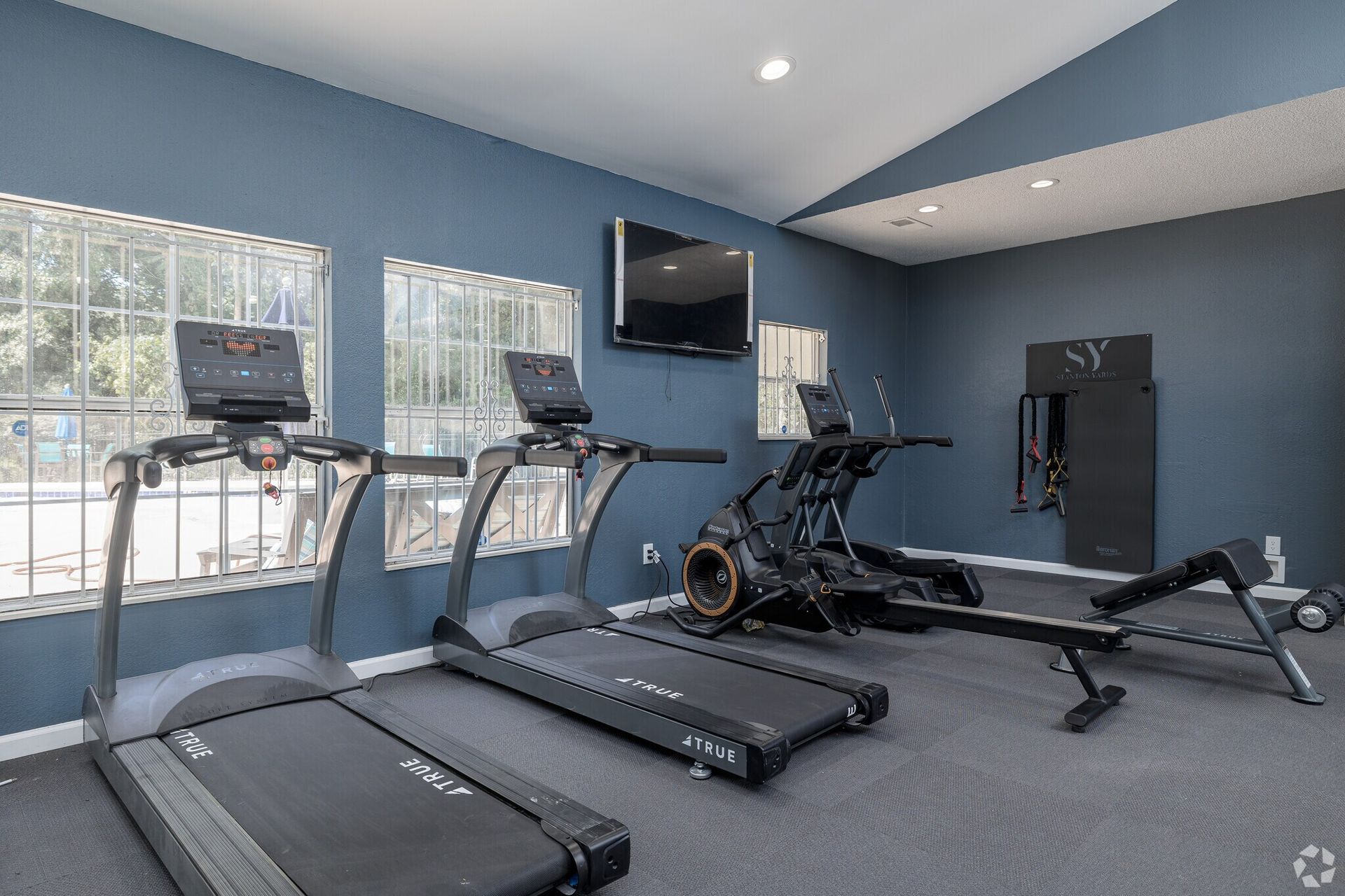 Photo of two treadmills at the fitness center, as well as a rowing machine.