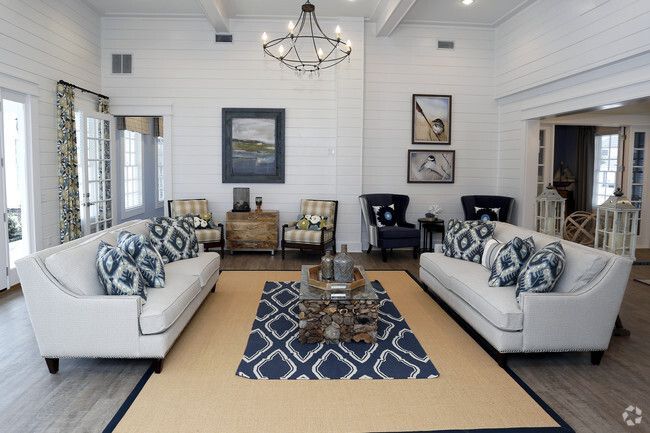 A community room with two couches and a rug