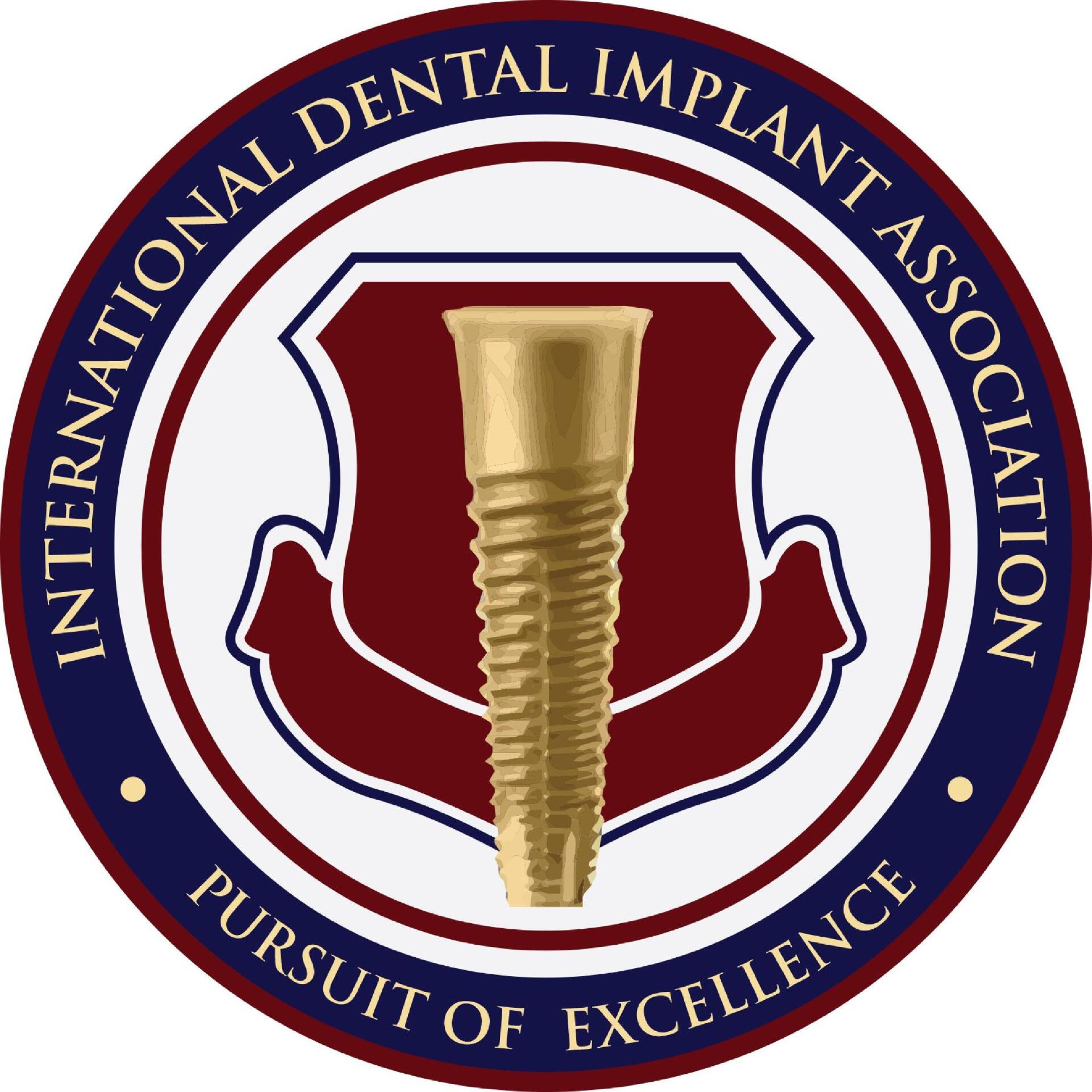 Logo: Gold dental implant within a maroon shield, surrounded by text “International Dental Implant Association” and “Pursuit of Excellence.”