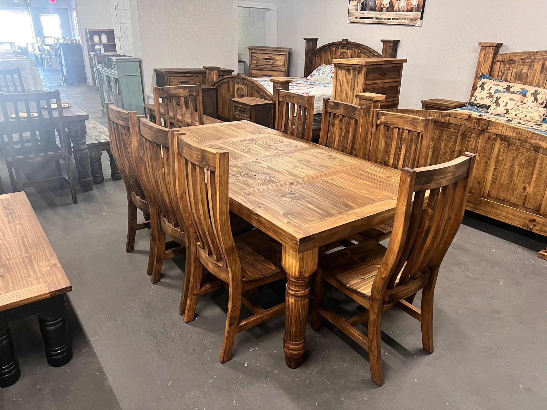 A wooden dining table set with six chairs and decorative plates.