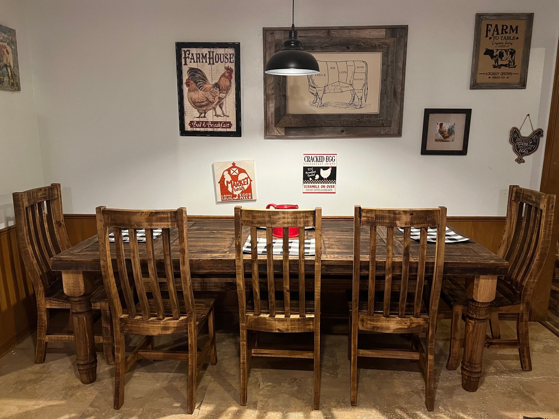 A rustic dining room with a wooden table, chairs.