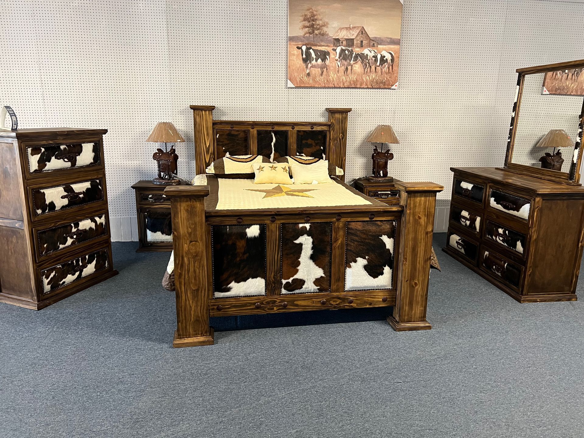 Western bedroom set: wooden bed, dresser, nightstands with cowhide accents.