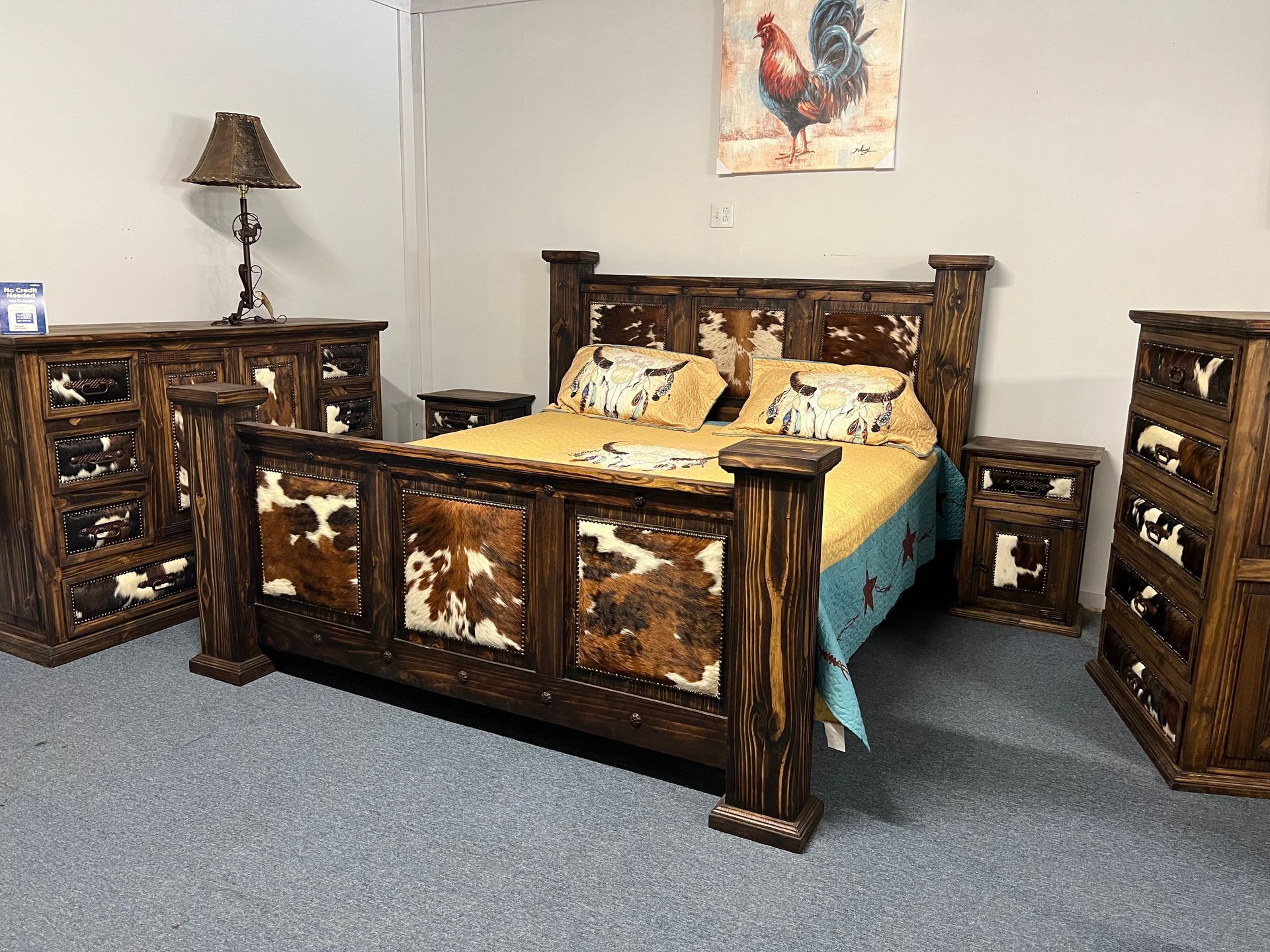 Bedroom set with cowhide accents, includes bed, nightstands, dresser, and chest.