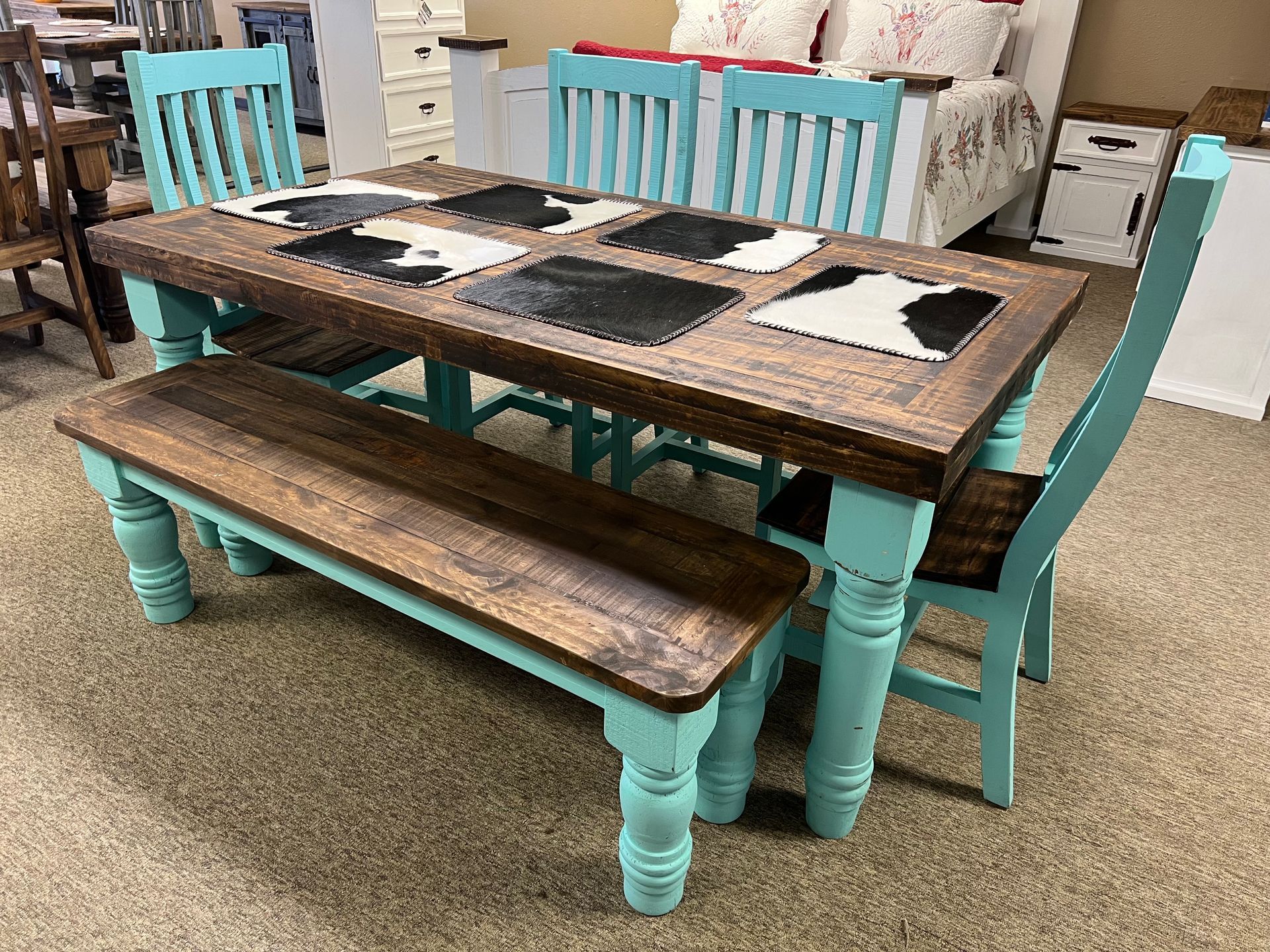 Rustic turquoise and brown dining table with bench and chairs.
