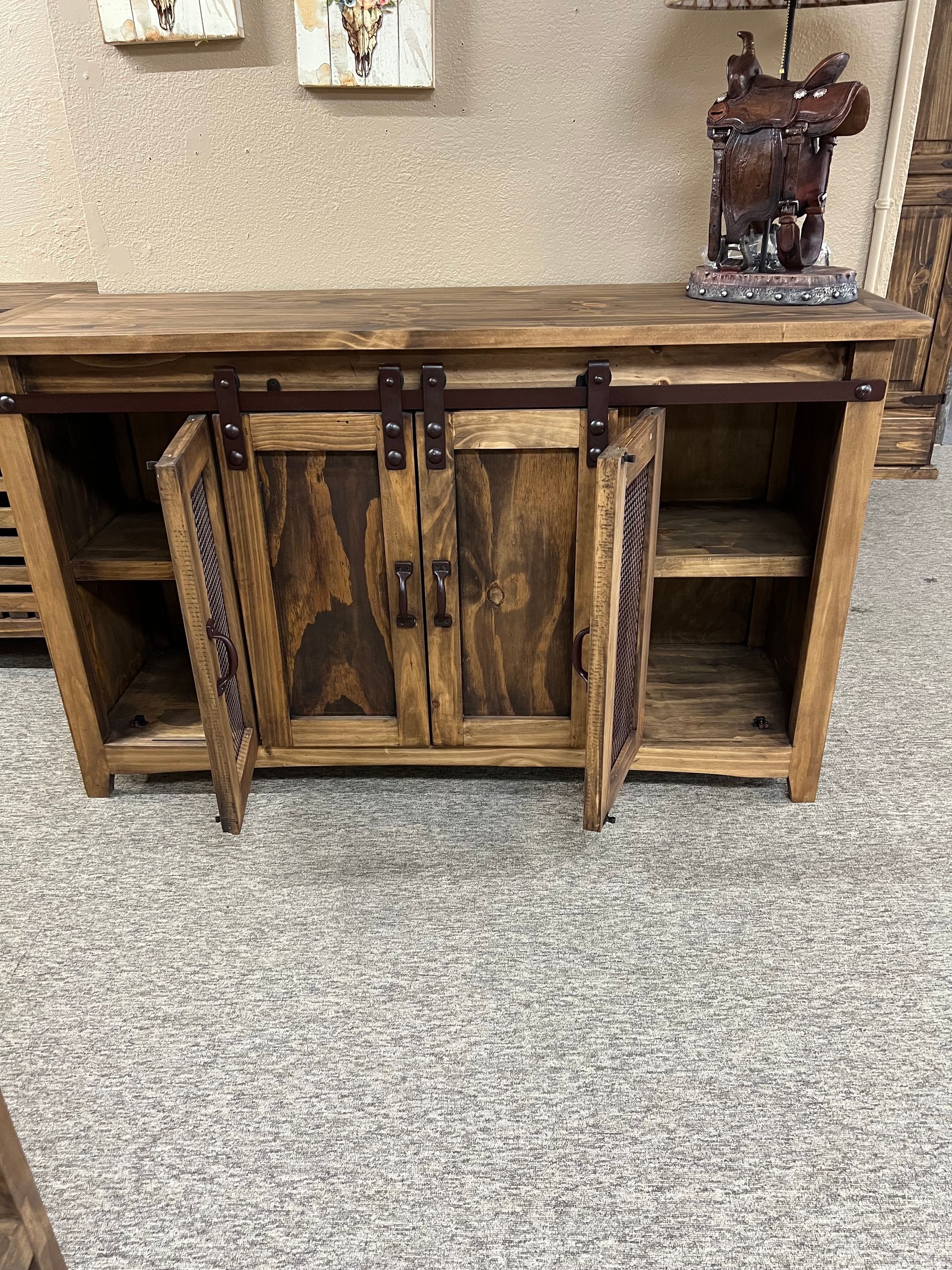 Wooden cabinet with mesh doors and a dark wood top.