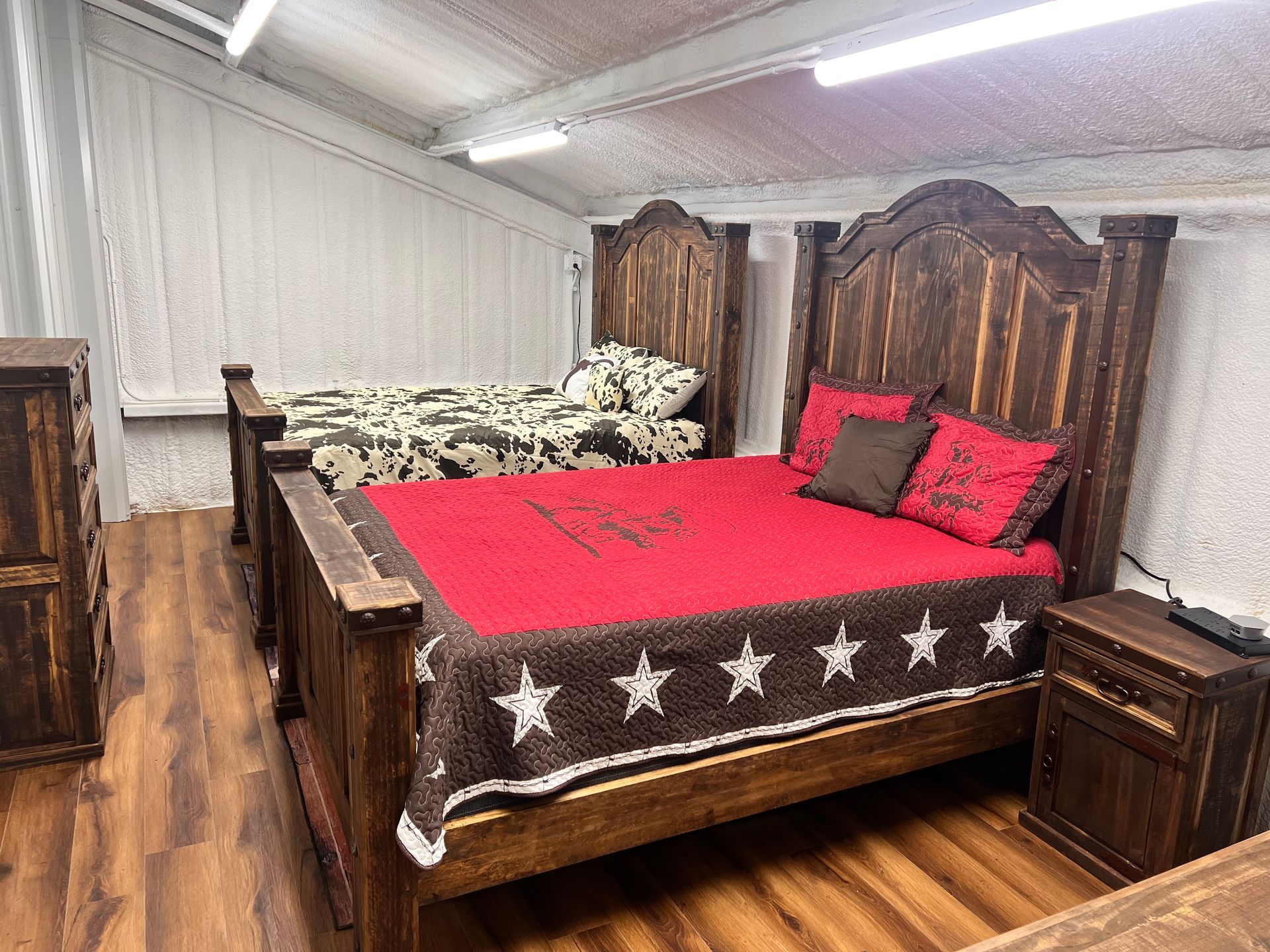 Rustic bedroom set with large wooden bed, nightstands, and dresser.